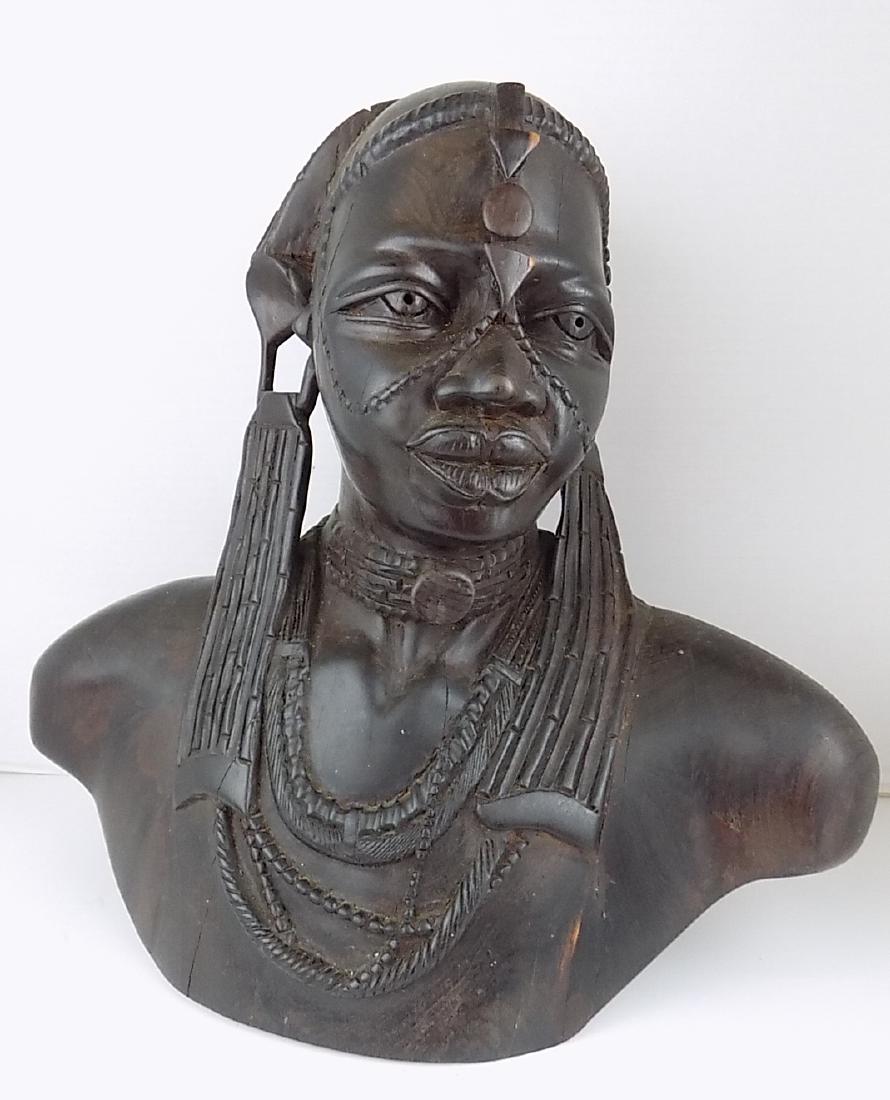 AFRICAN MAASAICARVED FEMALE HARDWOOD BUST: A CARVED AND SIGNED HARDWOOD FEMALE AFRICAN MAASAI TRIBAL BUST. SIGNED "KALUNDA". WOOD IS BELIEVED TO BE AN AFRICAN HARDWOOD, TEAK OR EBONY. MEASURES 14"H X 16"W.