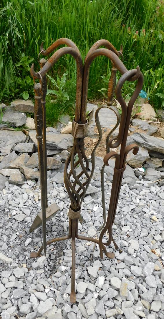 SIBERIAN WROUGHT IRON TOOL SET: A HAND FORGED SIBERIAN WROUGHT IRON FIREPLACE TOOLS SET. HOLDER IS A HAND FORGED TWISTED IRON WITH LEAF DECORATION. MEASURES 37.5"H.