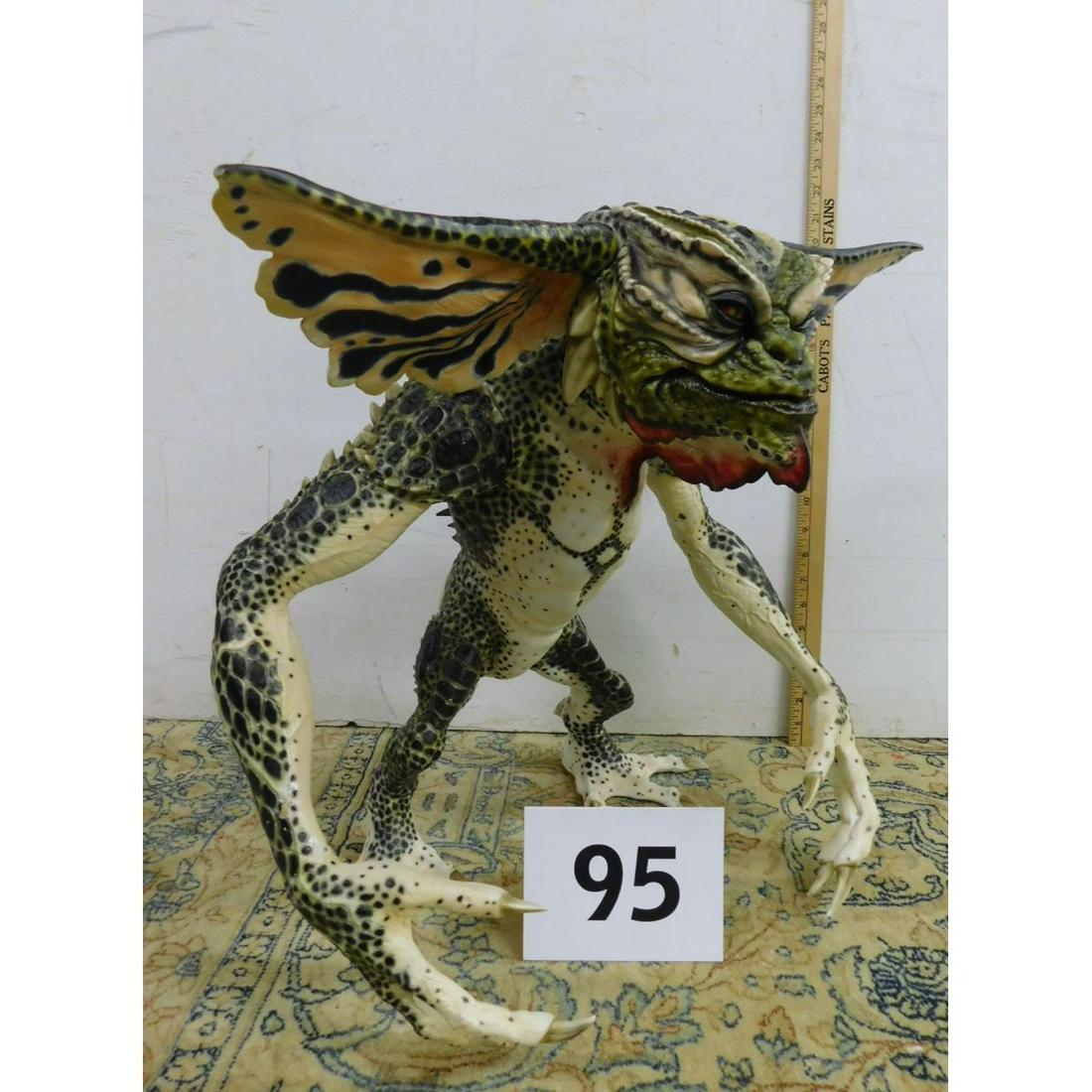 LARGE WARNER BROTHERS GREMLIN'S ALIEN FIGURE: A LARGE STAMPED WARNER BROTHERS 20" TALL GREMLIN'S ALIEN MONSTER FIGURINE. MADE OF A HARD COMPOSITE MATERIAL. PLEASE SEE PHOTOS ON CONDITION. IT DOES HAVE HAVE SOME CHIPS AND MISSING PIECES.