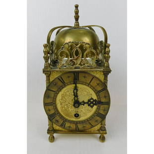 ORNATE BRASS FRENCH CLOCK: AN ORNATE BRASS CLOCK WITH DOUBLE FISH DECORATION AROUND THE TOP. 7 JEWELS UNADJUSTED WORKS BY DUVERDREY & BLOQUEL. NOT TESTED. MEASURES 9"H X 4" SQUARE.