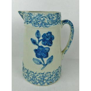 BLUE AND WHITE SPONGEWARE PITCHER: A BLUE AND WHITE STONWARE PITCHER WITH FLORAL DECORATION. MEASURES 9"H. DOES HAVE CHIP ON SPOUT. PLEASE SEE PHOTOGRAPH.