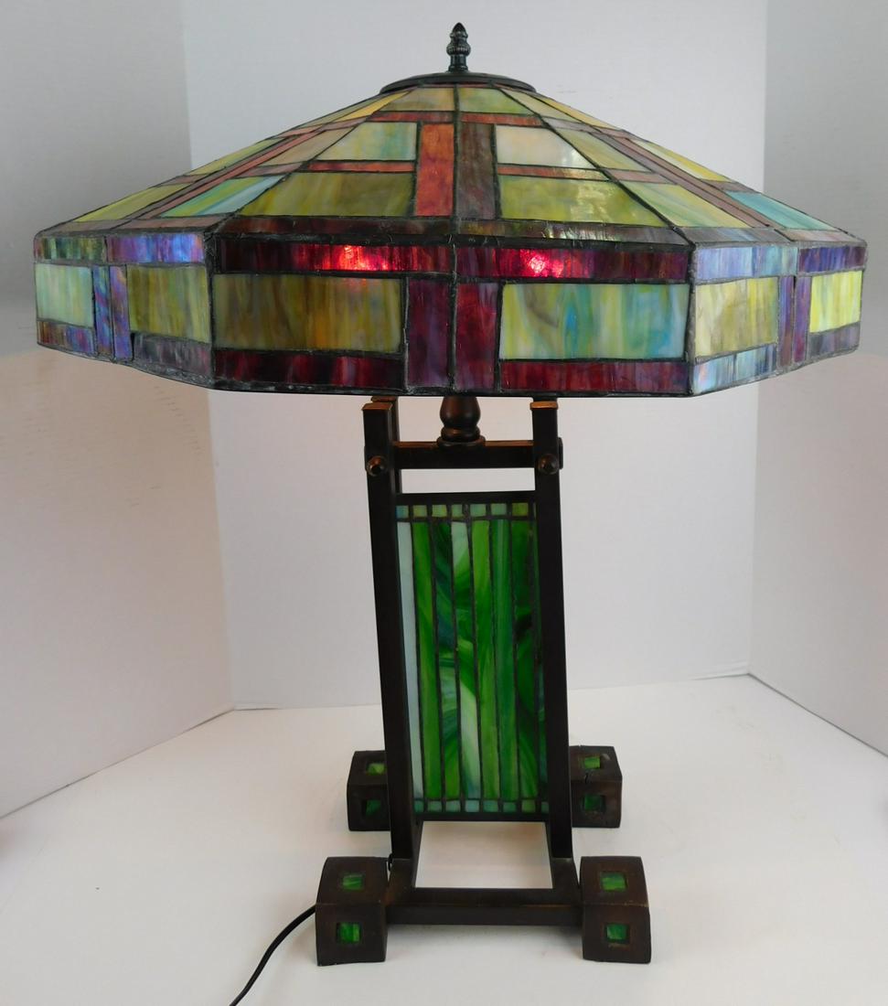 STAINED GLASS TABLE LAMP: A MULTI COLORED STAINED GLASS TABLE LAMP WITH LARGE STAINED GLASS SHADE AND BASE. TOTAL HEIGHT MEASURES 27"H. LAMP BASE ALONE MEASURES 19"H AND SHADE MEASURES 21"W. PLEASE SEE PHOTOGRAPHS AS THERE IS 