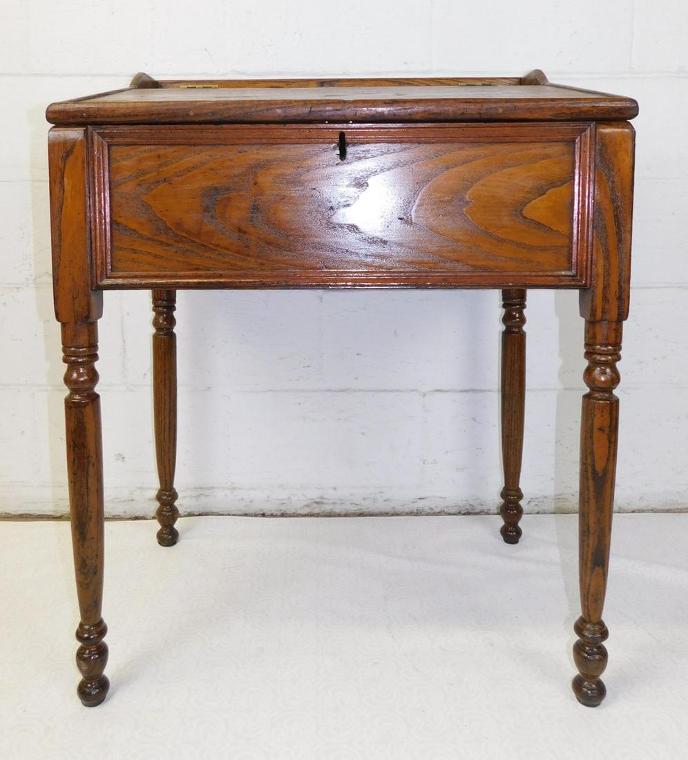 VINTAGE OAK WRITING DESK: A VINTAGE OAK SLANT FRONT WRITING DESK WITH TURNED LEGS. MEASURES 28"W X 20"D X 35.5"H.