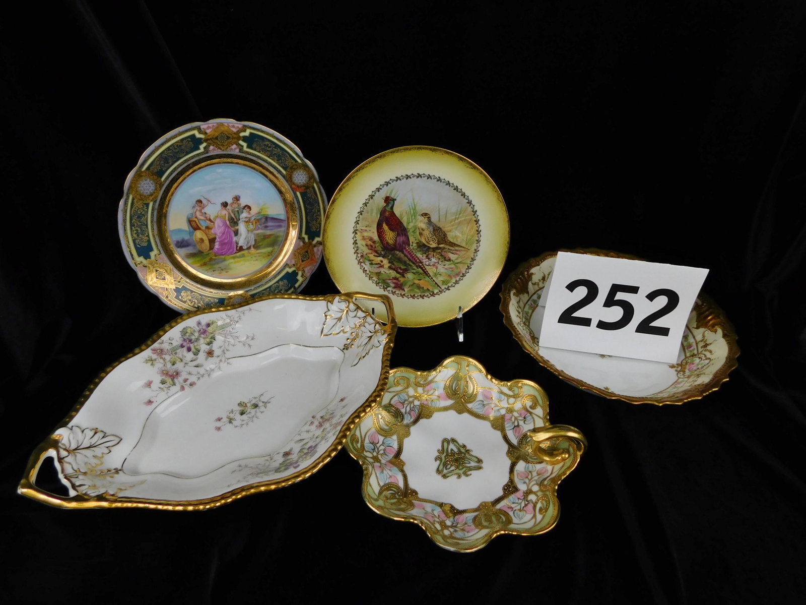 ASSORTED DECORATED PORCELAIN DISHES.: A LOT OF ASSORTED PORCELAIN DISHES. NAMES LIKE NIPPON, GERMANY, LIMOGES, AUSTRIA, AND IMPERIAL. LARGE DISH MEASURES 13"L X 9"W X 2.5"H.