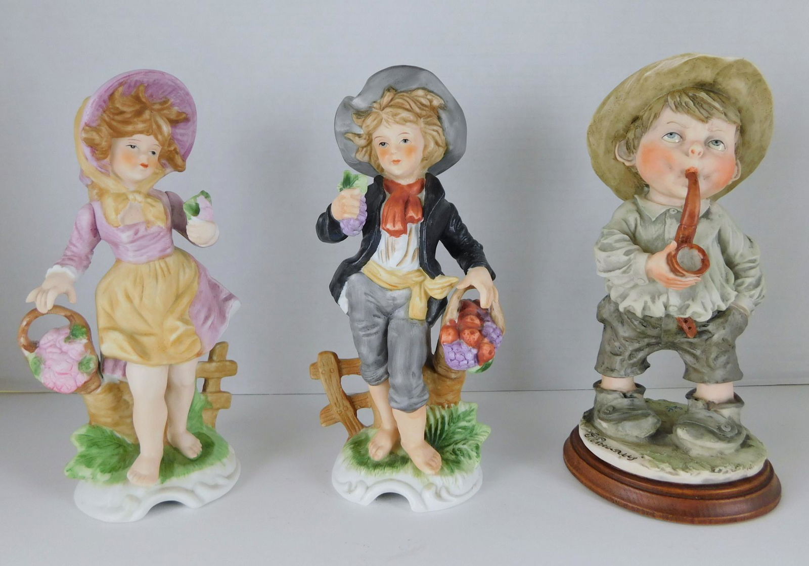 THREE CAPODIMONTE PORCELAIN FIGURINE: A LOT OF THREE CAPODIMONTE PORCELAIN FIGURINES. PLEASE SEE PHOTOGRAPHS. MEASURE APPROX 8"H EACH.