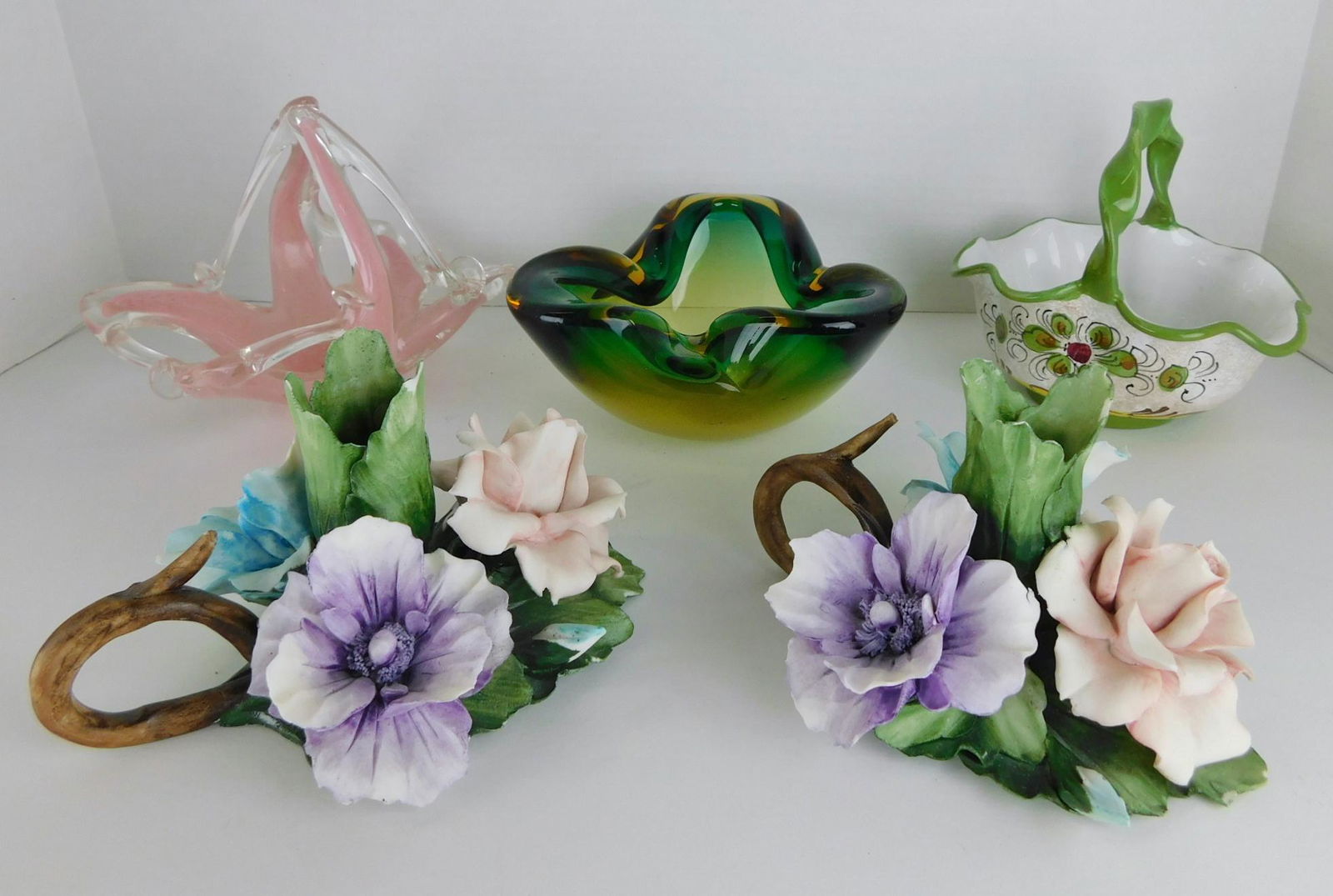 ART GLASS AND CAPODIMONTE LOT: A LOT OF ART GLASS BOWLS, DECORATED PORCELAIN BASKET, AND CAPODIMONTE FLORAL CANDLESTICK HOLDERS. SOME CHIPS ON THE PORCELAIN FLOWERS. MEASURES 2.5" TO 5.5"H.
