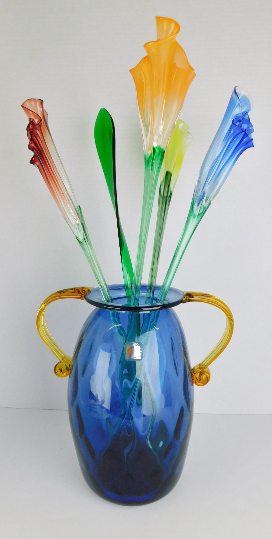 BLENKO VASE WITH GLASS FLOWERS: AN ART GLASS BLENKO VASE WITH SWUNG GLASS FLOWERS. MEASURES 18.5" WITH FLOWERS AND 9.5" VASE ONLY.