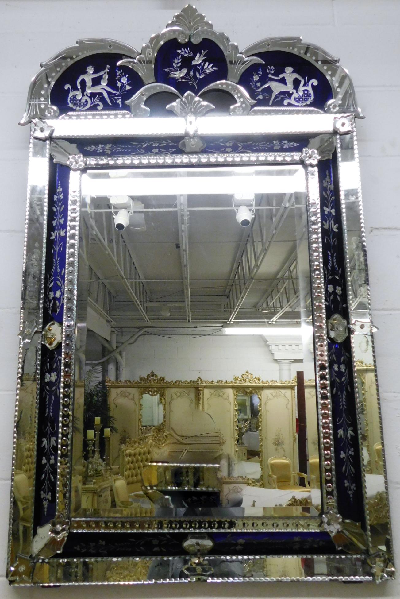 ETCHED ART DECO VENETIAN MIRROR: AN ETCHED VENETIAN ART DECO MIRROR WITH COBALT BLUE TO CLEAR ETCHED INSERTS. FIGURAL TOP PANELS. PLEASE NOTE THAT THERE ARE SOME GAPS BETWEEN PANELS. PLEASE SEE PHOTOGRAPHS. MEASURES 58"H X 33.5"W.