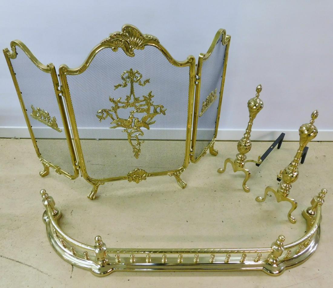 POLISHED BRASS FIREPLACE SET: A FOUR PIECE BRASS FIREPLACE SET. INCLUDES DECORATED CLAW FOOT SCREEN MEASURESING 29.5"H X 41"L, FENDER MEASURING 50"L, AND ANDIRONS MEASURING 18"D.
