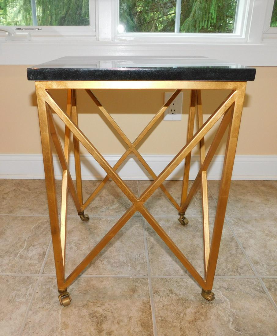 BLACK GRANITE TOP STAND: A BLACK GRANITE TOP SQUARE STAND WITH METAL BASE. METAL CASTER WHEELS. MEASURES 16" SQUARE X 22"H.