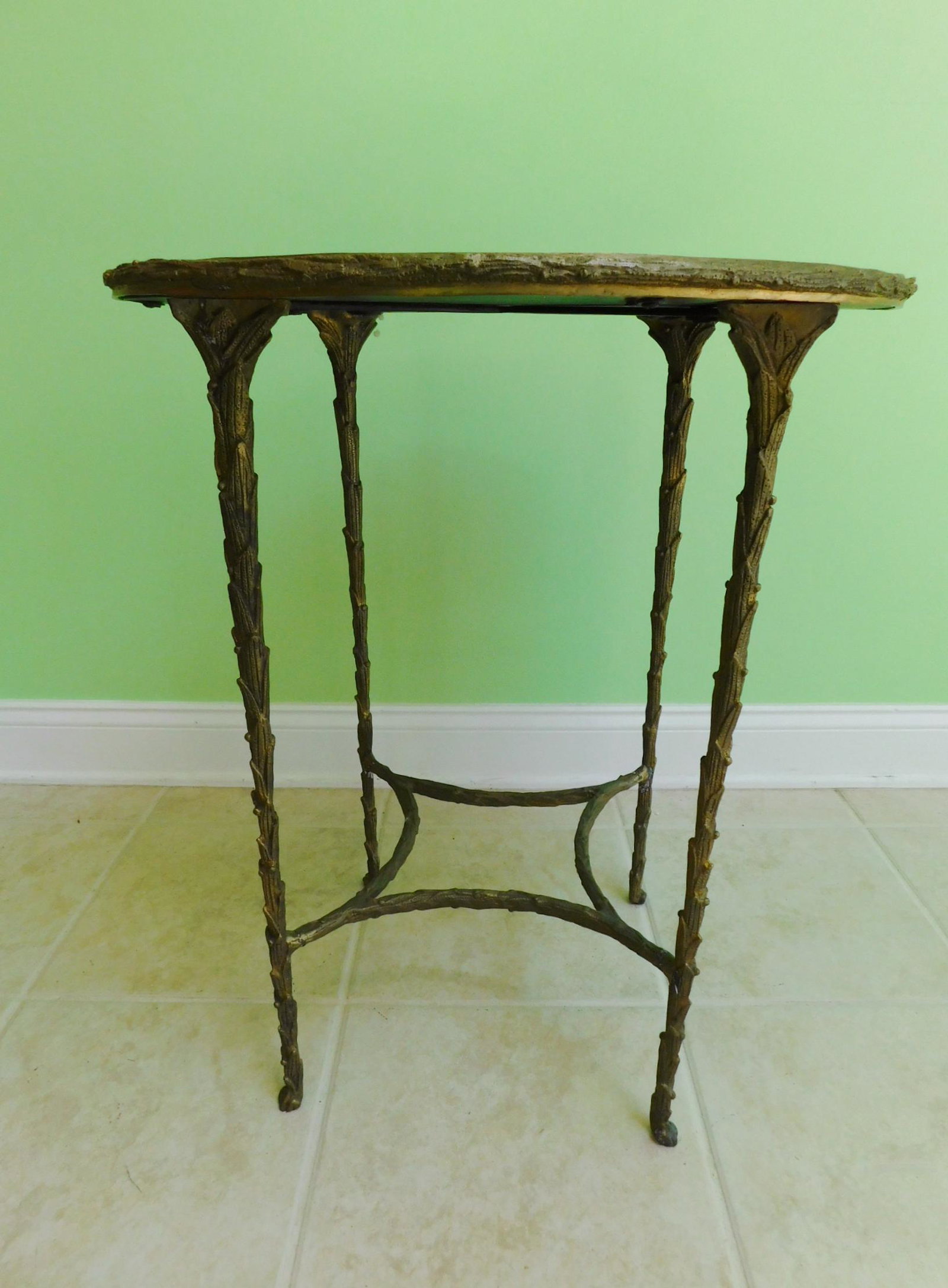 DECORATED ROUND GLASS TOP IRON TABLE: A DECORATED ROUND GLASS TOP IRON BASE TABLE. MEASURES 20.5" DIAMETER X 24"H.