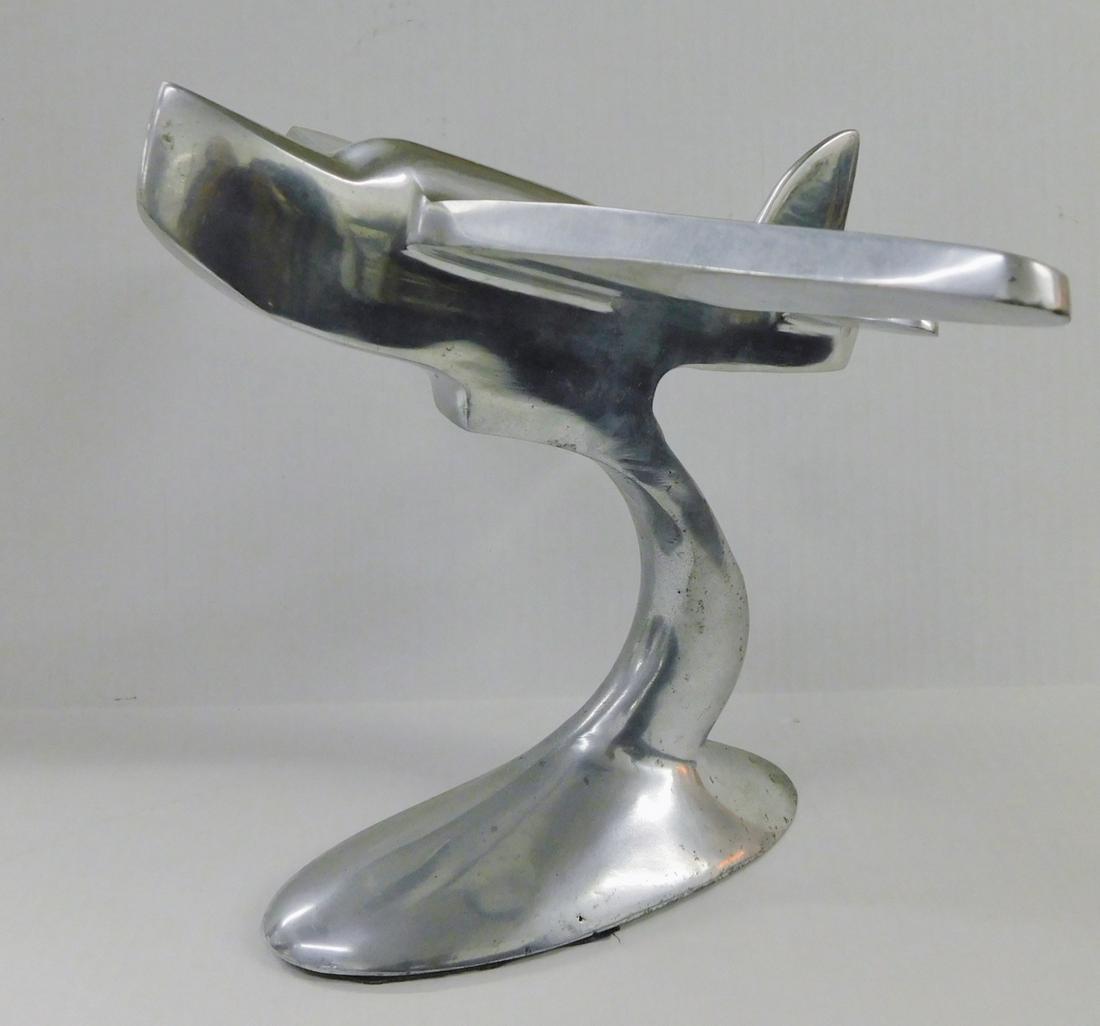 METAL AIRPLANE FIGURE: A METAL AIRPLANE DESKTOP FIGURE. MEASURES 9"H X 10"W. PLEASE SEE PHOTOGRAPHS.