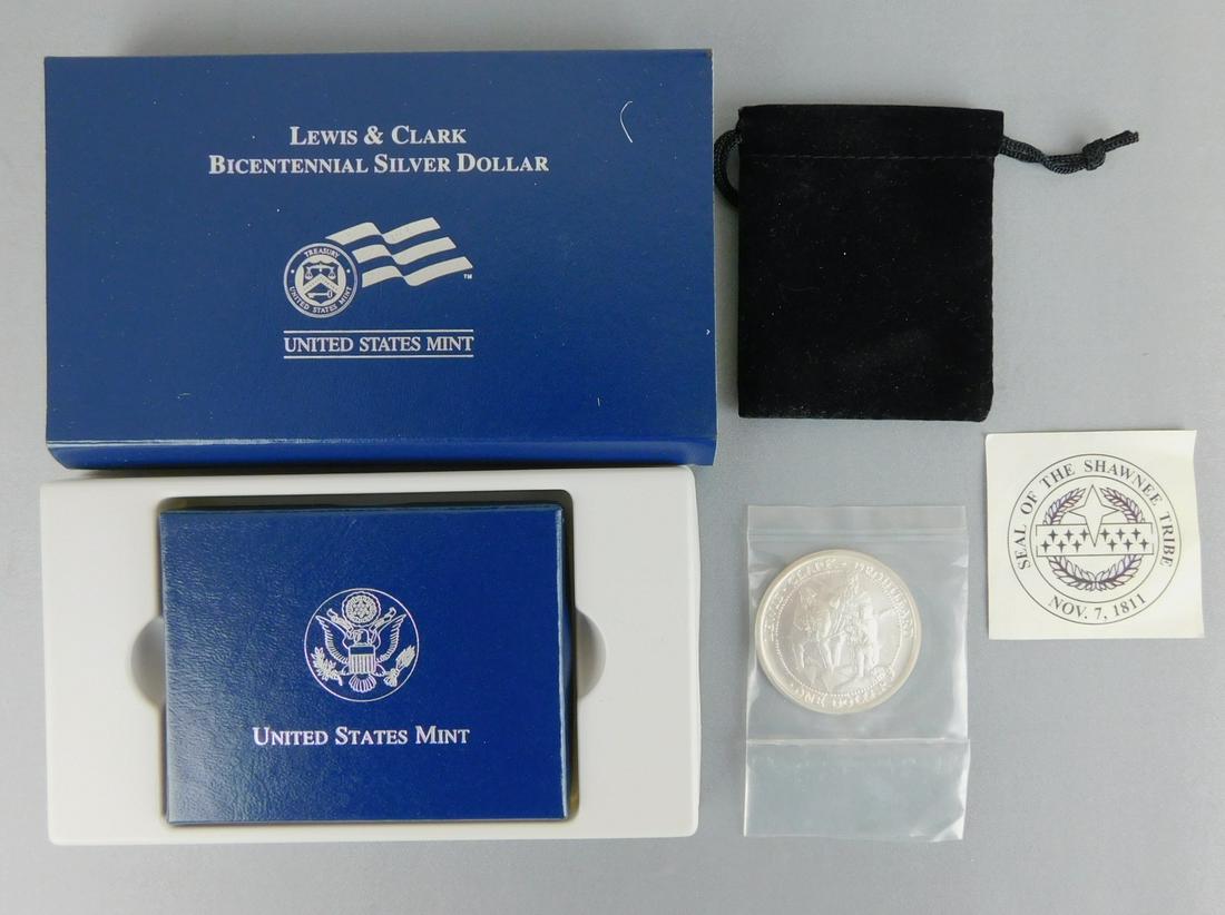 LEWIS AND CLARK SILVER COIN LOT: A LOT OF TWO LEWIS AND CLARK SILVER DOLLAR COINS. ONE 2003 SHAWNEE TRIBE DOLLAR, AND ONE BICENTENNIAL SILVER DOLLAR.