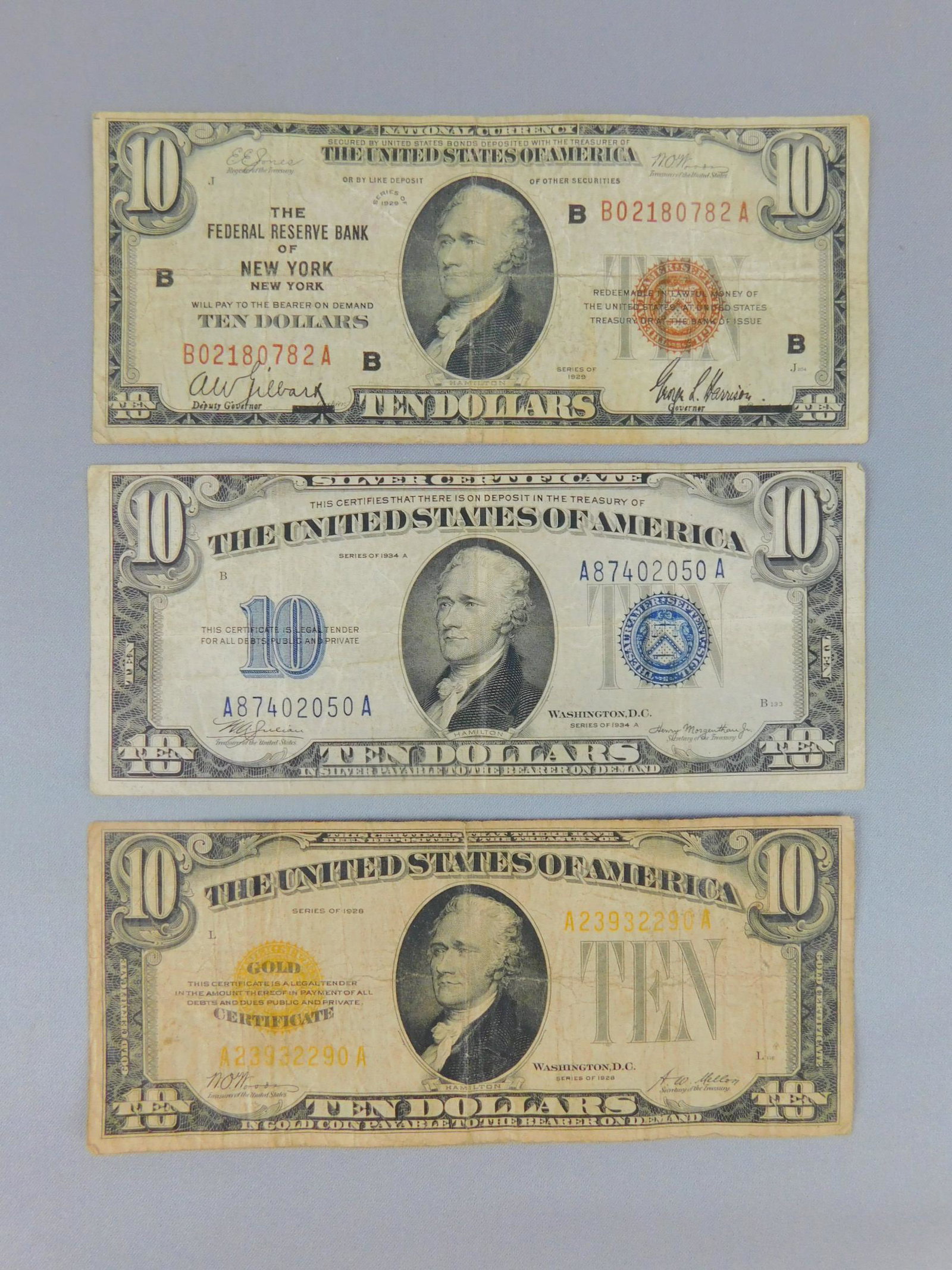 $10 GOLD, SILVER, AND FEDERAL RESERVE NOTES: A LOT OF THREE $10 NOTES INCLUDING SILVER, GOLD, AND FEDERAL RESERVE OF NEW YORK. VG, VF.