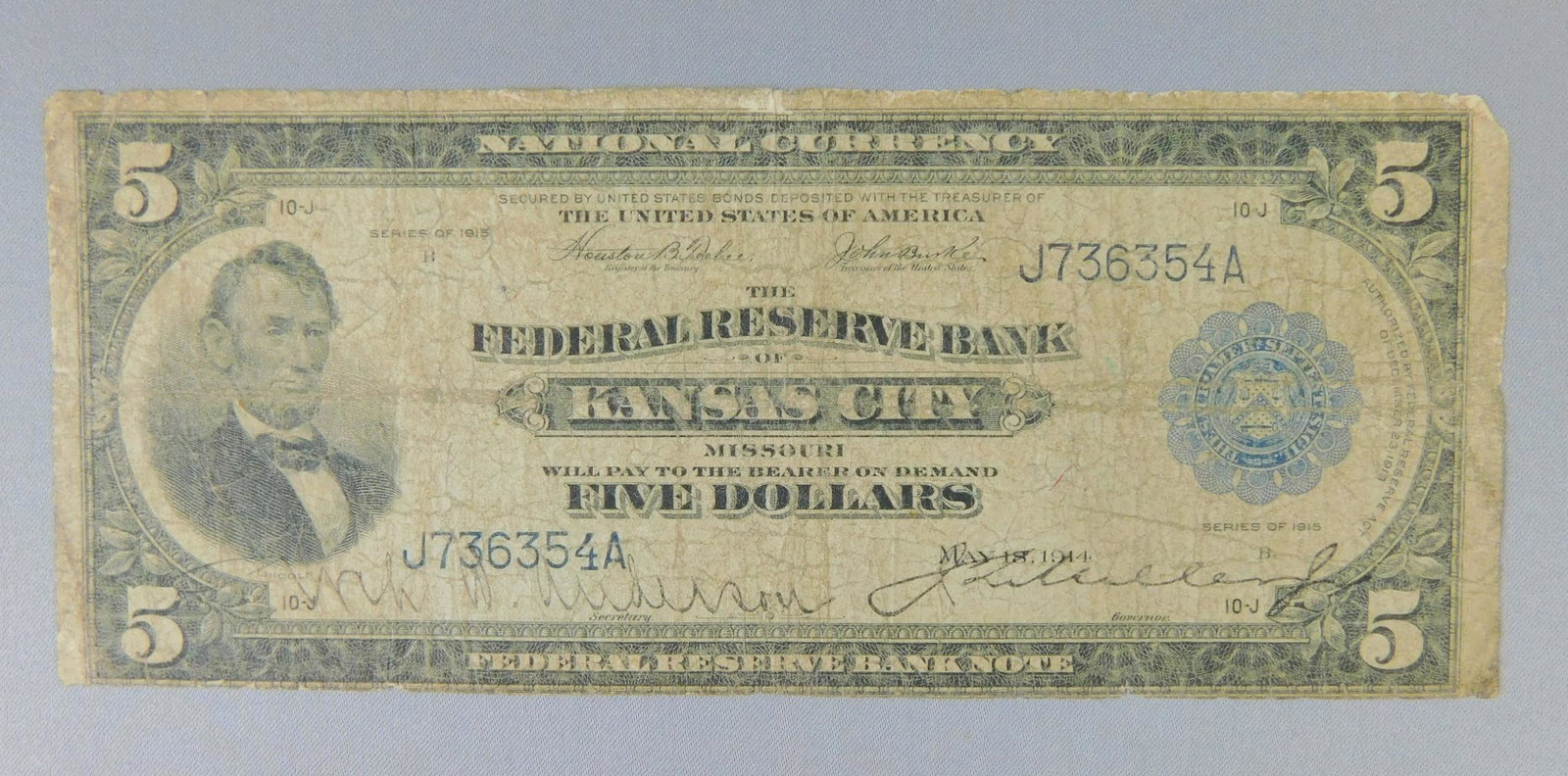 1914 $5 KANSAS CITY FEDERAL RESERVE BANK: 1914 $5 KANSAS CITY FEDERAL RESERVE BANK. PIN HOLES AND EDGE TEARS NOTED.