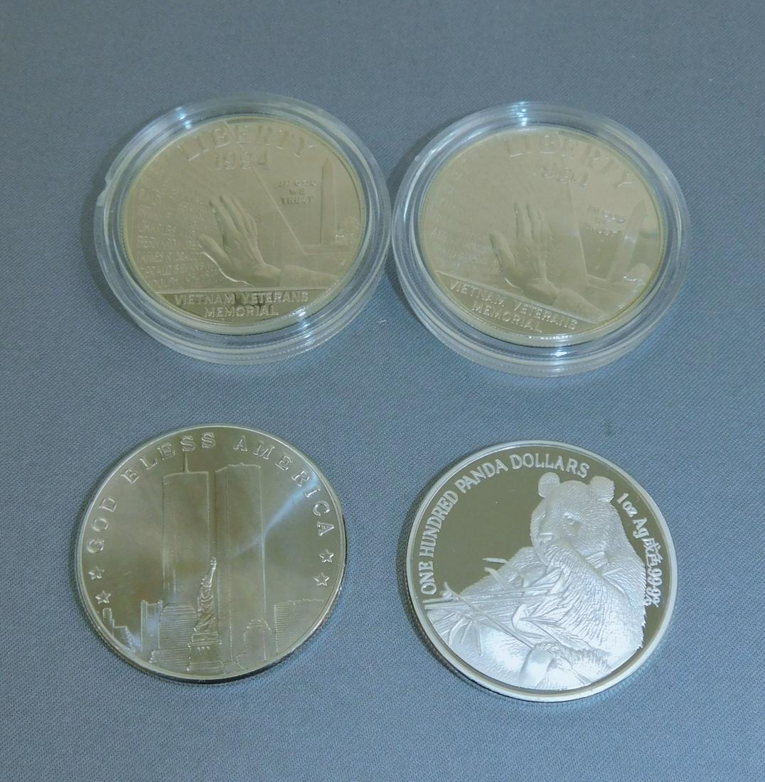 4 SILVER ROUNDS: SILVER ROUND PANDA; WTC COMMEMORATIVE & (2 COUNT) VIETNAM VETERANS MEMORIAL ROUNDS