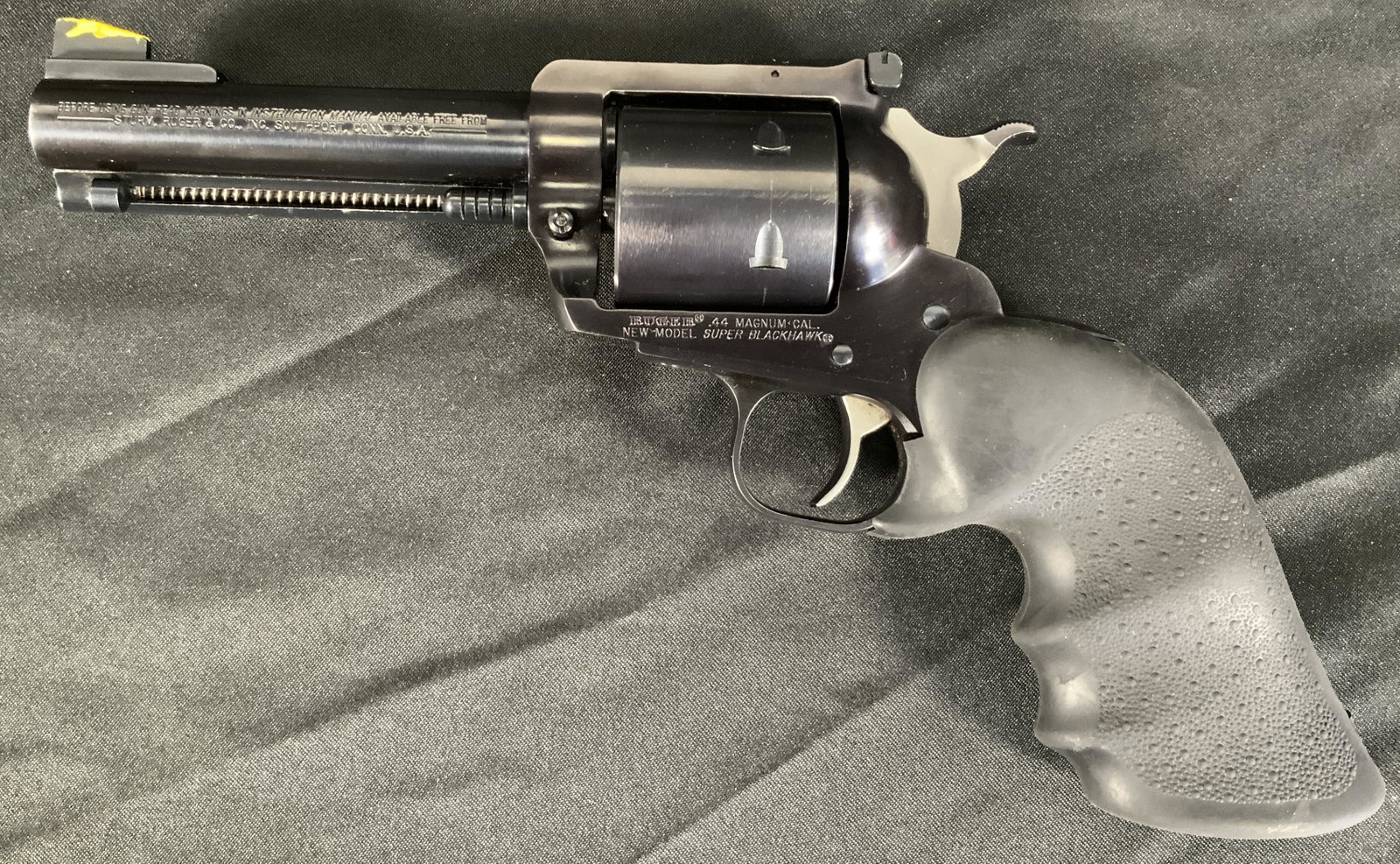 RUGER NEW MODEL SUPER BLACK HAWK 44 MAG WITH HOGUE GRIPS.: RUGER NEW MODEL SUPER BLACK HAWK 44 MAG WITH HOGUE GRIPS. SERIAL NUMBER 86-91283. THIS FIREARM NEEDS TO BE REGISTERED.