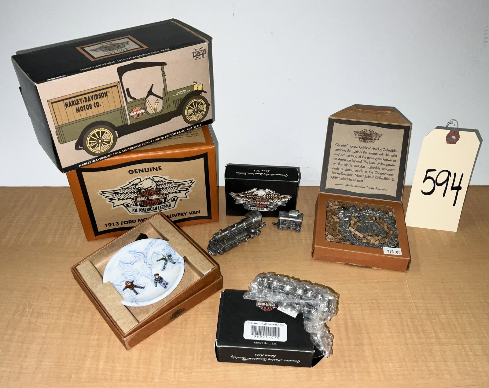 6 PC HD COLLECTOR PCS.: 6 PC HD COLLECTOR PCS. LOT INCLUDES 2 MINI PEWTER TRAIN SETS, PEWTER SANTA AND MINI PLATES, AND TRUCK BANKS. Condition All property is sold in "as is" condition and all sales are final. Teel Auctions