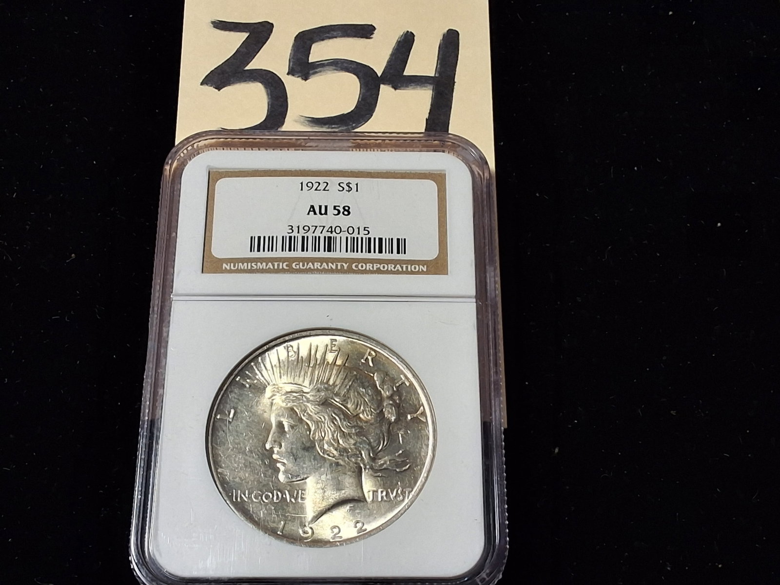 1922 Peace Dollar $1 NGC AU58: 1922 Peace Dollar $1 NGC AU58 Condition All property is sold in "as is" condition and all sales are final. Teel Auctions and its consignor make no representations or warranties, express or implied, wi