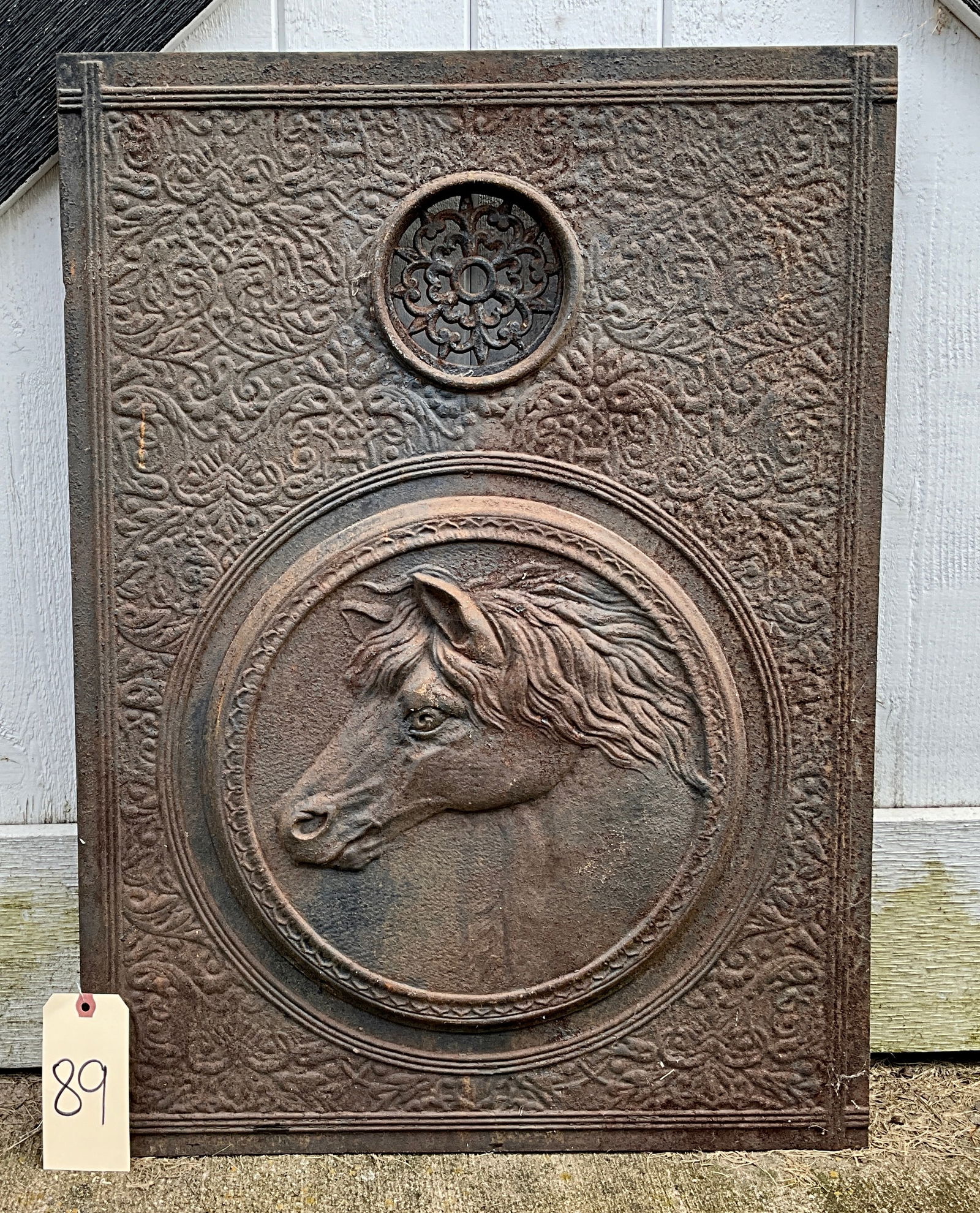 VICTORIAN HORSE HEAD DECORATED CAST IRON STOVE COVER.: VICTORIAN HORSE HEAD DECORATED CAST IRON STOVE COVER. MEASURES 21" X 29". Condition All property is sold in "as is" condition and all sales are final. Teel Auctions and its consignor make no represent
