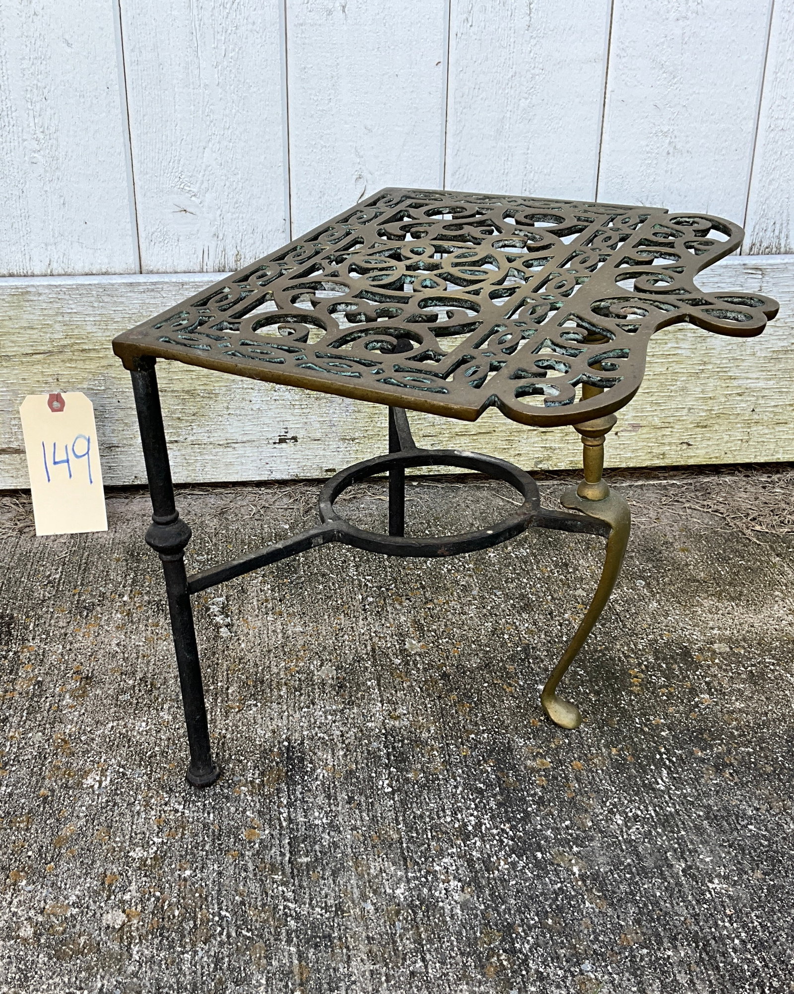 ANTIQUE BRASS TRIVET.: ANTIQUE BRASS TRIVET. MEASURES 13" X 11" X 12"H. Condition All property is sold in "as is" condition and all sales are final. Teel Auctions and its consignor make no representations or warranties, exp