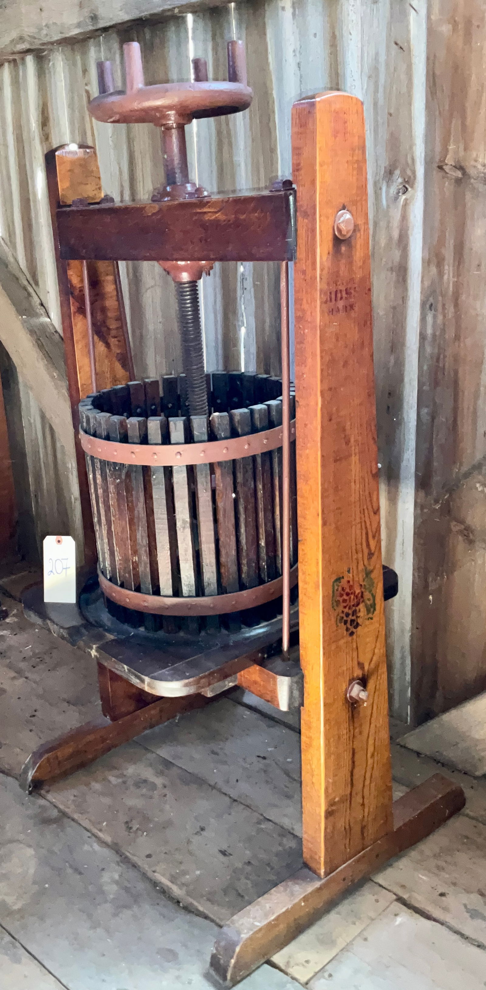 BOSS MARK WINE PRESS.: BOSS MARK WINE PRESS. MEASURES 29" X 24" X 54"H. HAND PAINTED GRAPES ON THE SIDE. PRESS PIECES INSIDE. Condition All property is sold in "as is" condition and all sales are final. Teel Auctions and it
