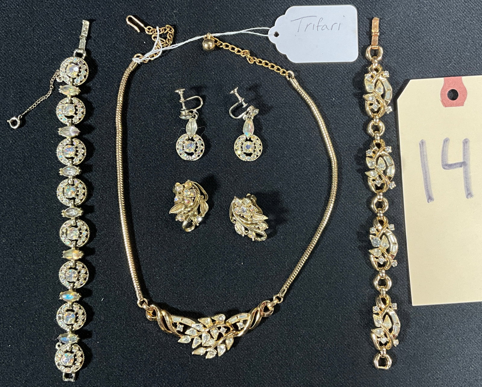 TRIFARI NECKLACE, EARRINGS, AND BRACELET SET WITH ANOTHER UNMARKED CRYSTAL DECORATED BRACELET.: TRIFARI NECKLACE, EARRINGS, AND BRACELET SET WITH UNMARKED CRYSTAL DECORATED BRACELET. Condition All property is sold in "as is" condition and all sales are final. Teel Auctions and its consignor make