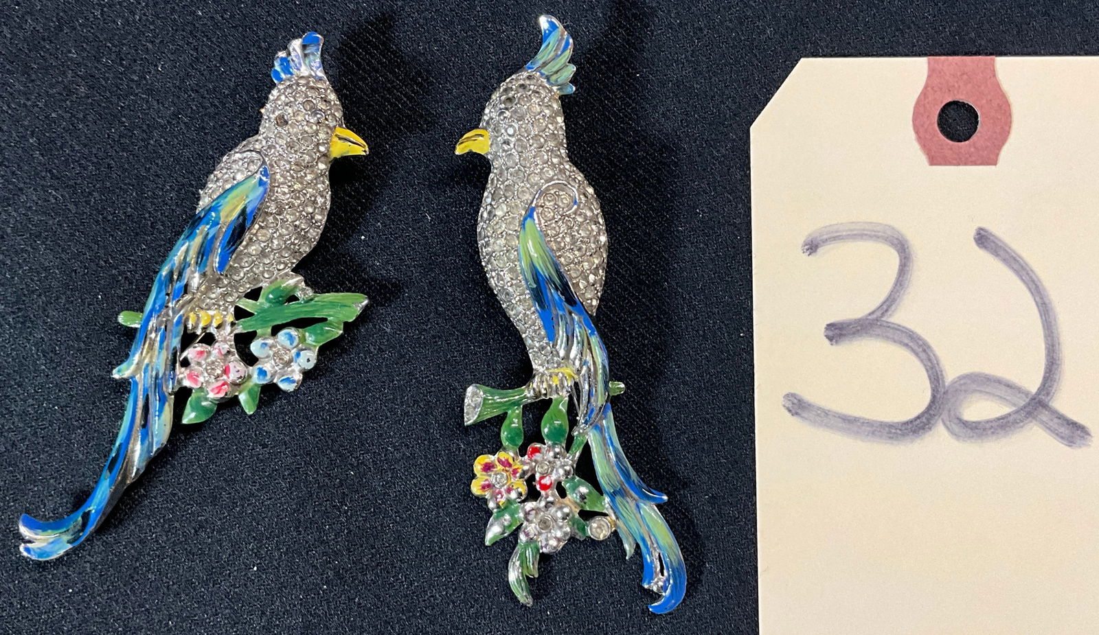 PAIR OF CORO DUETTE ENAMEL PAINTED RHINESTONE PARROT BROOCHES.: PAIR OF CORO DUETTE ENAMEL PAINTED RHINESTONE PARROT BROOCHES. Condition All property is sold in "as is" condition and all sales are final. Teel Auctions and its consignor make no representations or w