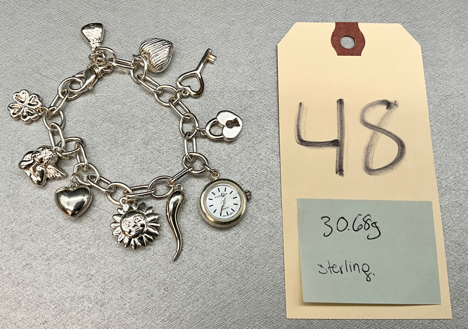 STERLING SILVER CHARM AND WATCH BRACELET. (1 of 2)