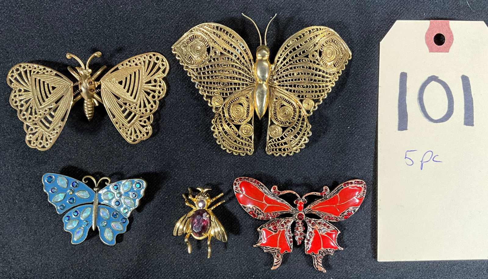 5 PC BUTTERFLY AND BEETLE BROOCHES.: FROM CORO, AVON, AND OTHERS. Condition All property is sold in "as is" condition and all sales are final. Teel Auctions and its consignor make no representations or warranties, express or implied, wit