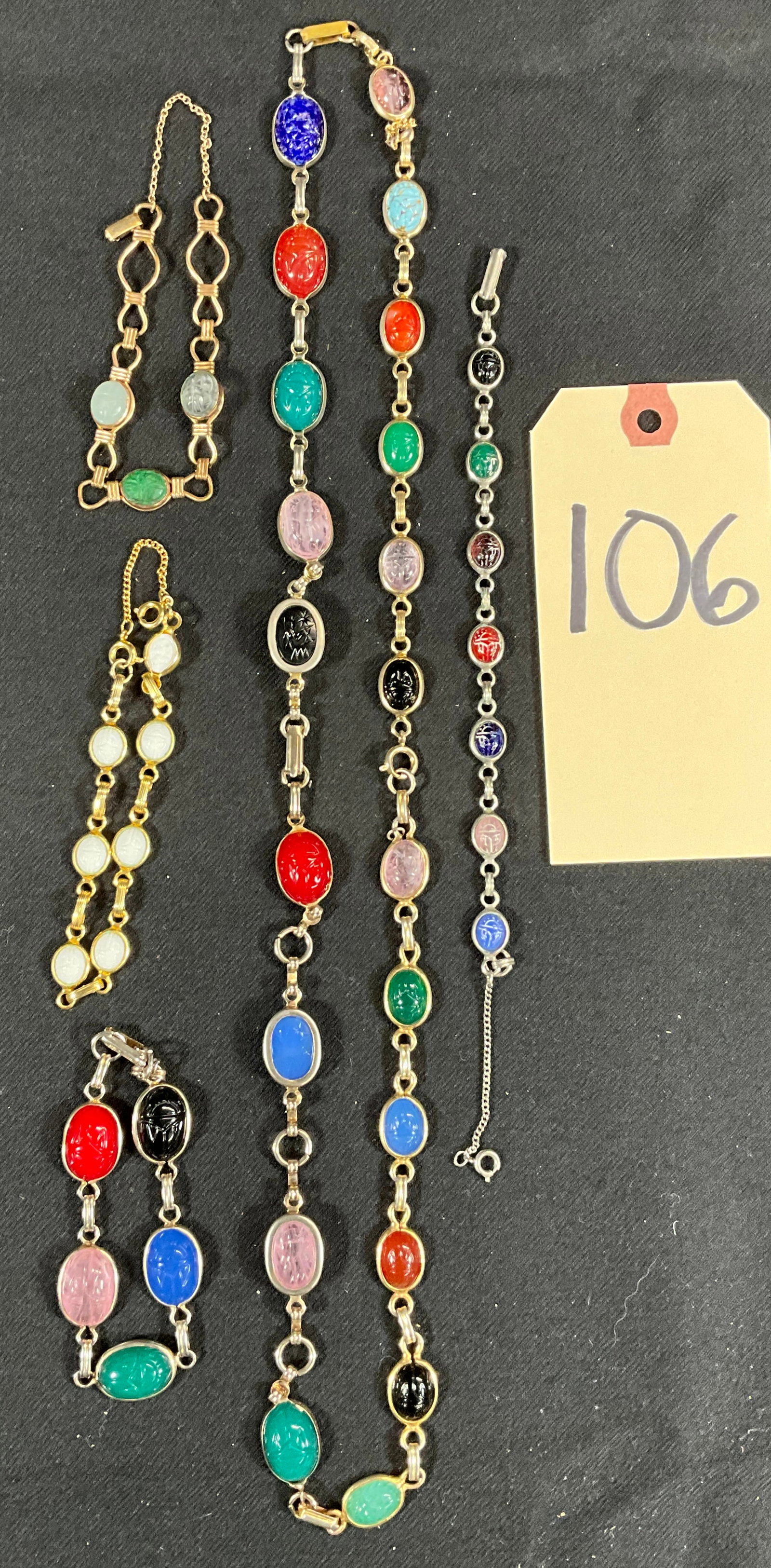 5 PC SCARAB BRACELETS AND NECKLACE.: 5 PC SCARAB BRACELETS AND NECKLACE. 8" BRACELETS AND 28" NECKLACE. Condition All property is sold in "as is" condition and all sales are final. Teel Auctions and its consignor make no representations 
