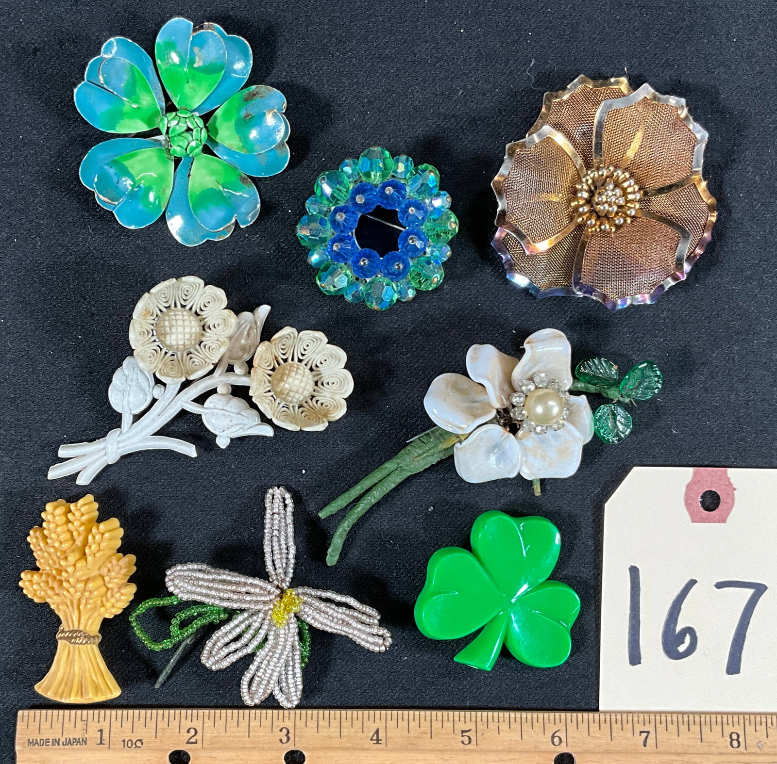 8 PC PLASTIC, COMPOSITE, AND METAL FLORAL BROOCHES.: 8 PC PLASTIC, COMPOSITE, AND METAL FLORAL BROOCHES. Condition All property is sold in "as is" condition and all sales are final. Teel Auctions and its consignor make no representations or warranties, 