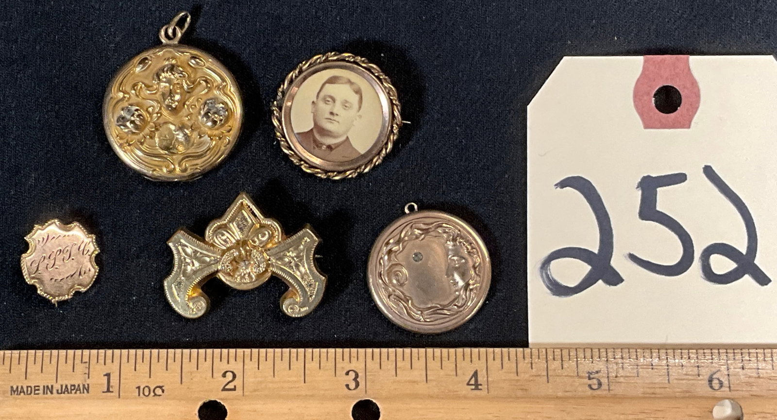 VINTAGE DECORATED PENDANTS AND PINS.: VINTAGE DECORATED PENDANTS AND PINS. Condition All property is sold in "as is" condition and all sales are final. Teel Auctions and its consignor make no representations or warranties, express or impl
