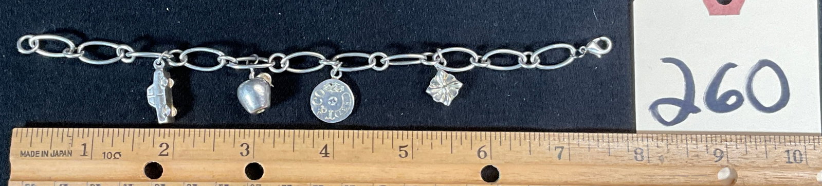 STERLING SILVER CHARM BRACELET.: STERLING SILVER CHARM BRACELET. TOTAL WEIGHT 23.32 GRAMS. ONE MARKED T & CO. Condition All property is sold in "as is" condition and all sales are final. Teel Auctions and its consignor make no repres