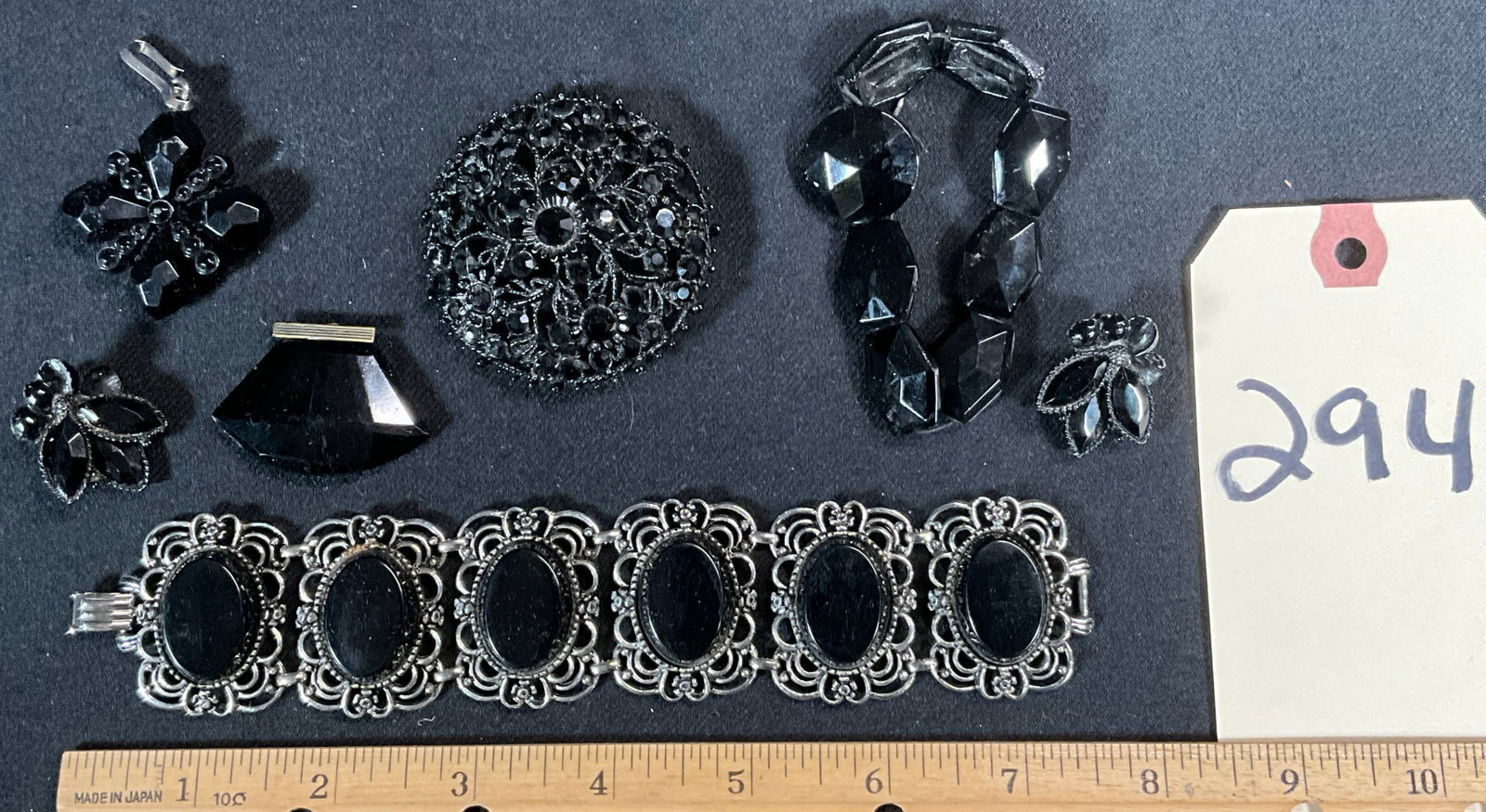 VINTAGE BLACK MOURNING JEWELRY.: VINTAGE BLACK MOURNING JEWELRY. INCLUDES PENDANTS, BROOCH, BRACELETS, AND EARRINGS. MARKED EMMONS, WEISS, AND OTHERS. Condition All property is sold in "as is" condition and all sales are final. Teel 