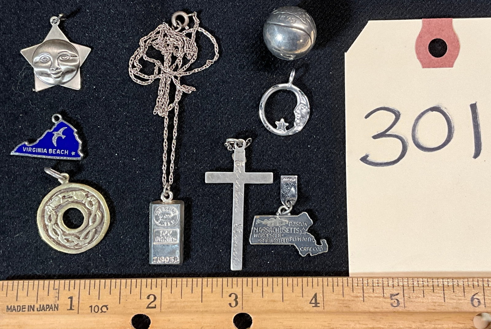 6 PC STERLING SILVER CHARMS, CROSS, AND BAR PENDANT NECKLACE.: 6 PC STERLING SILVER CHARMS, CROSS, AND BAR PENDANT NECKLACE. TOTAL WEIGHT 23.88 GRAMS. Condition All property is sold in "as is" condition and all sales are final. Teel Auctions and its consignor mak