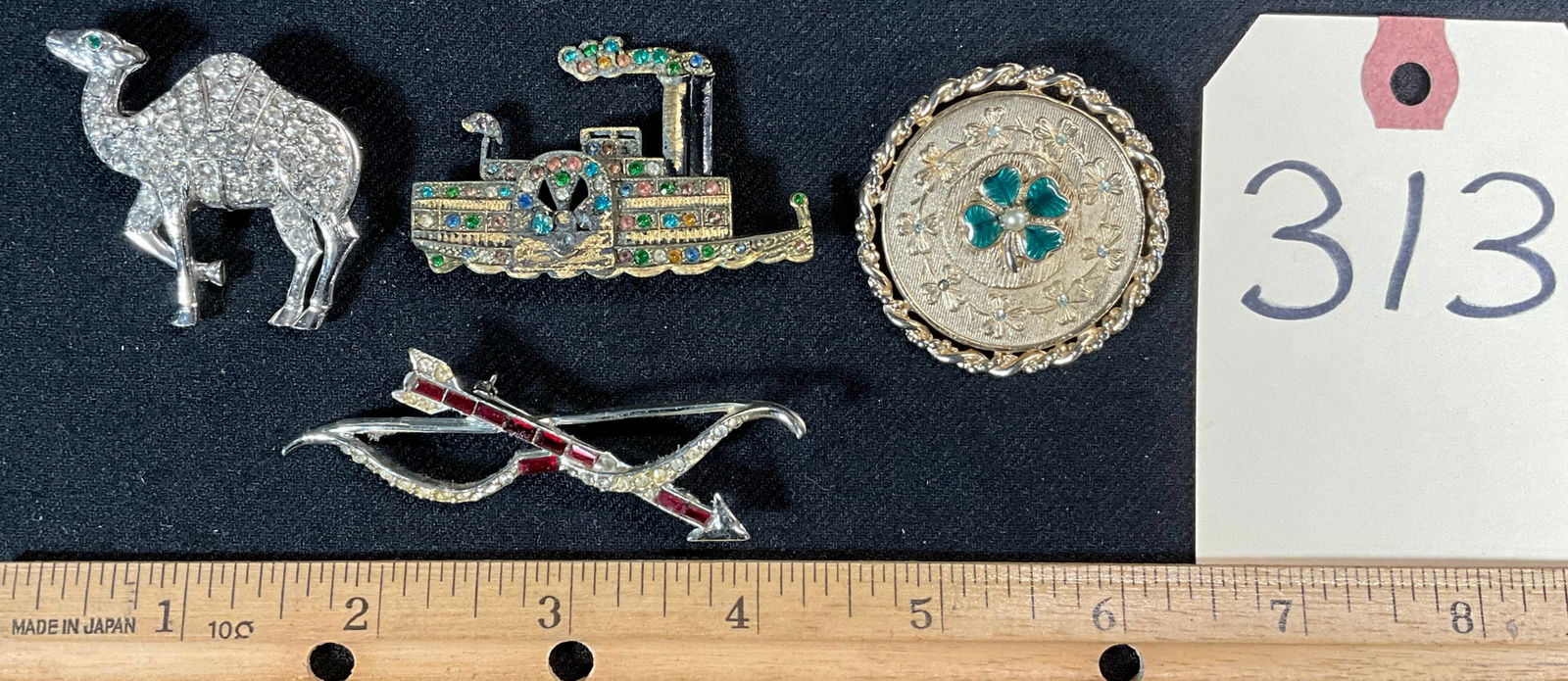 STEAMBOAT, CAMEL, BOW, AND CLOVER BROOCHES.: STEAMBOAT, CAMEL, BOW, AND CLOVER BROOCHES. MARKED ORA, CORO, AND MORE. Condition All property is sold in "as is" condition and all sales are final. Teel Auctions and its consignor make no representat