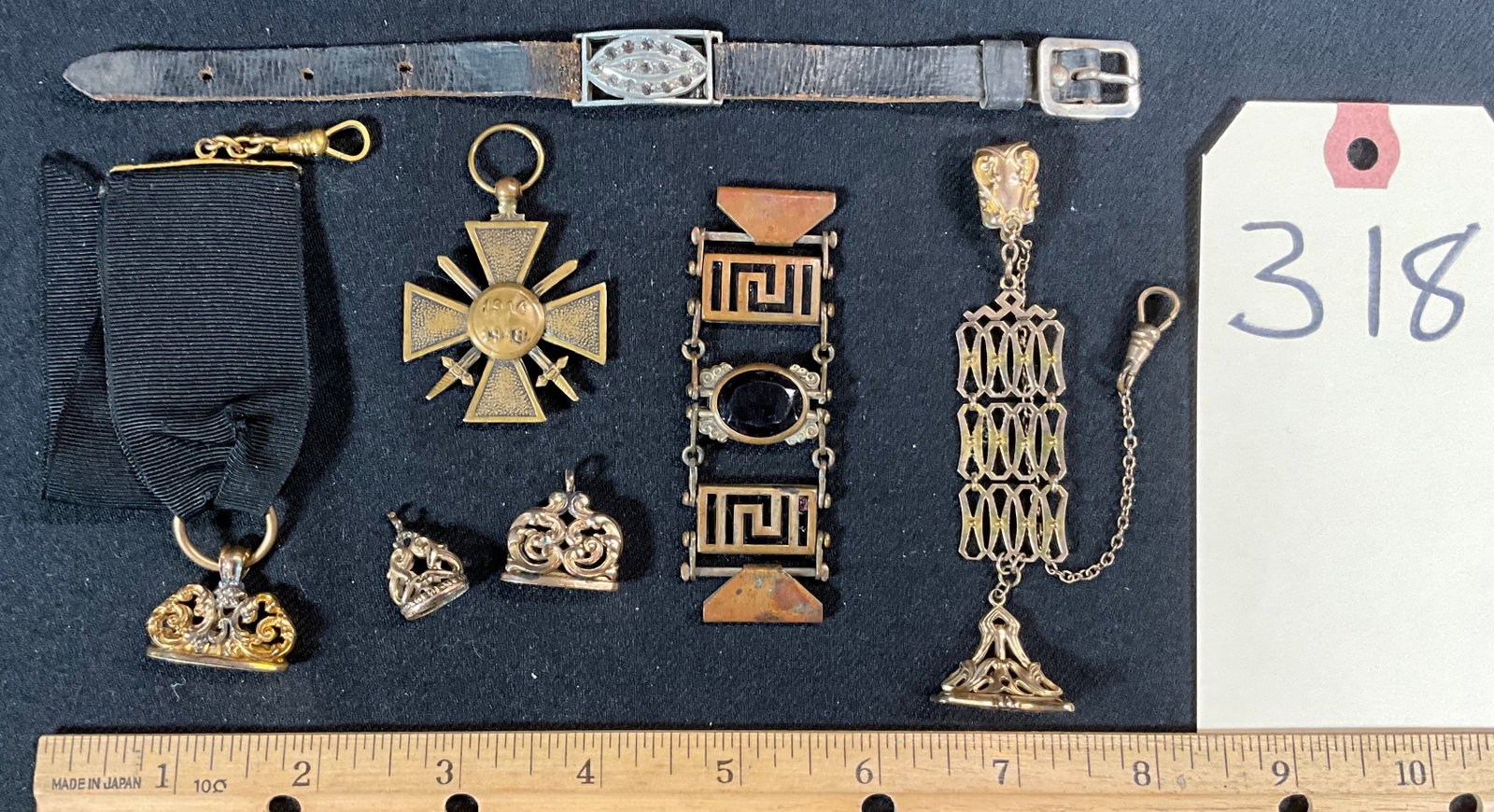 ASSORTED VICTORIAN WATCH FOBS, COAT OF ARMS PENDANT, AND MORE.: ASSORTED VICTORIAN WATCH FOBS, COAT OF ARMS PENDANT, AND MORE. Condition All property is sold in "as is" condition and all sales are final. Teel Auctions and its consignor make no representations or w