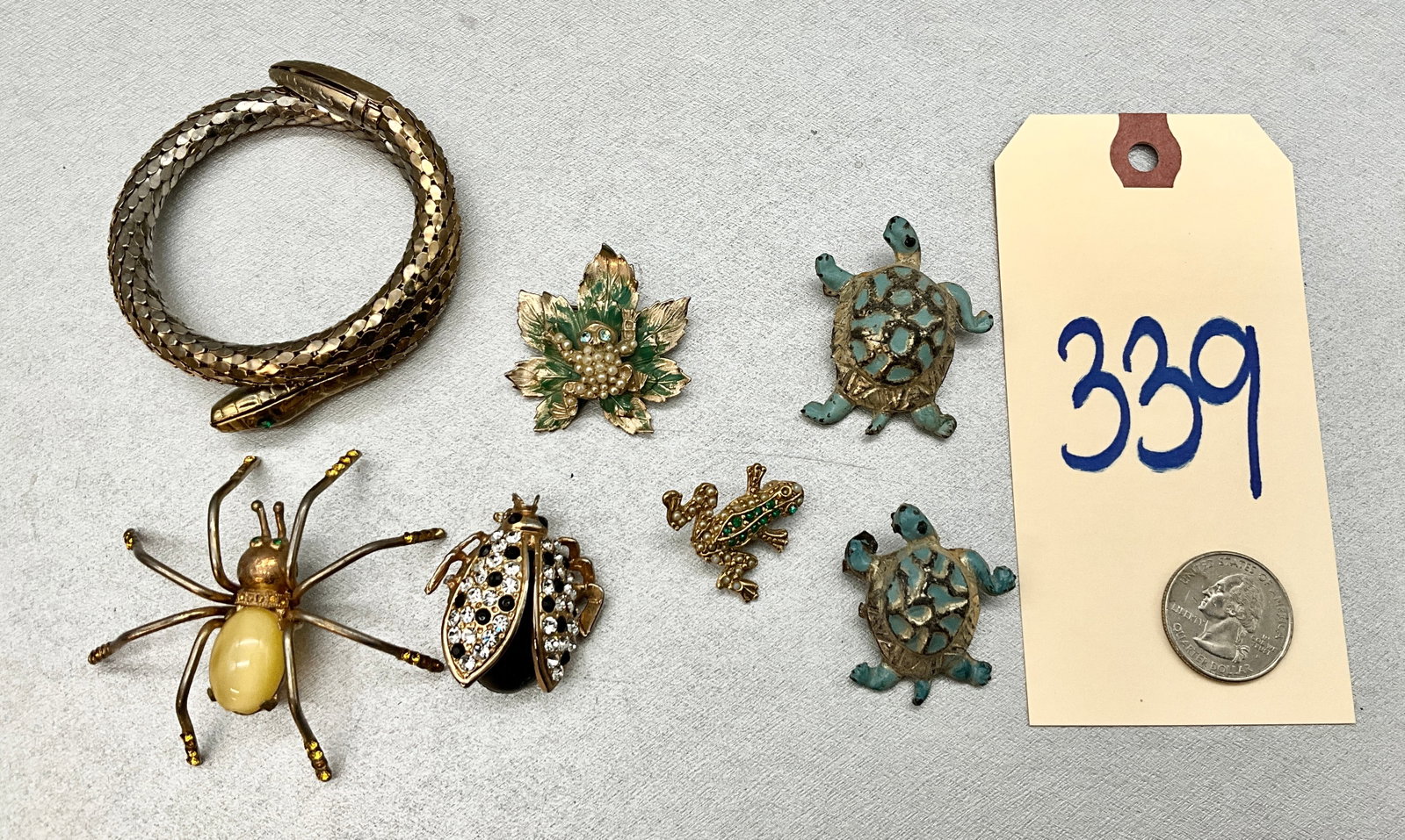 7 PC ASSORTED FROG, SPIDER, BEATLE, AND SNAKE JEWELRY.: 7 PC ASSORTED FROG, SPIDER, BEATLE, AND SNAKE JEWELRY. Condition All property is sold in "as is" condition and all sales are final. Teel Auctions and its consignor make no representations or warrantie