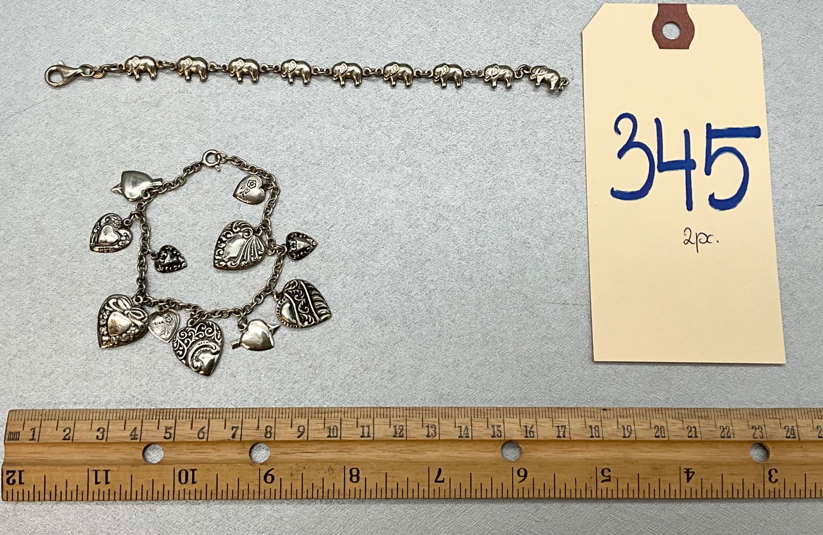 2 PC STERLING SILVER CHARM BRACELETS. TOTAL 21.36 GRAMS.: 2 PC STERLING SILVER CHARM BRACELETS. TOTAL 21.36 GRAMS. Condition All property is sold in "as is" condition and all sales are final. Teel Auctions and its consignor make no representations or warrant