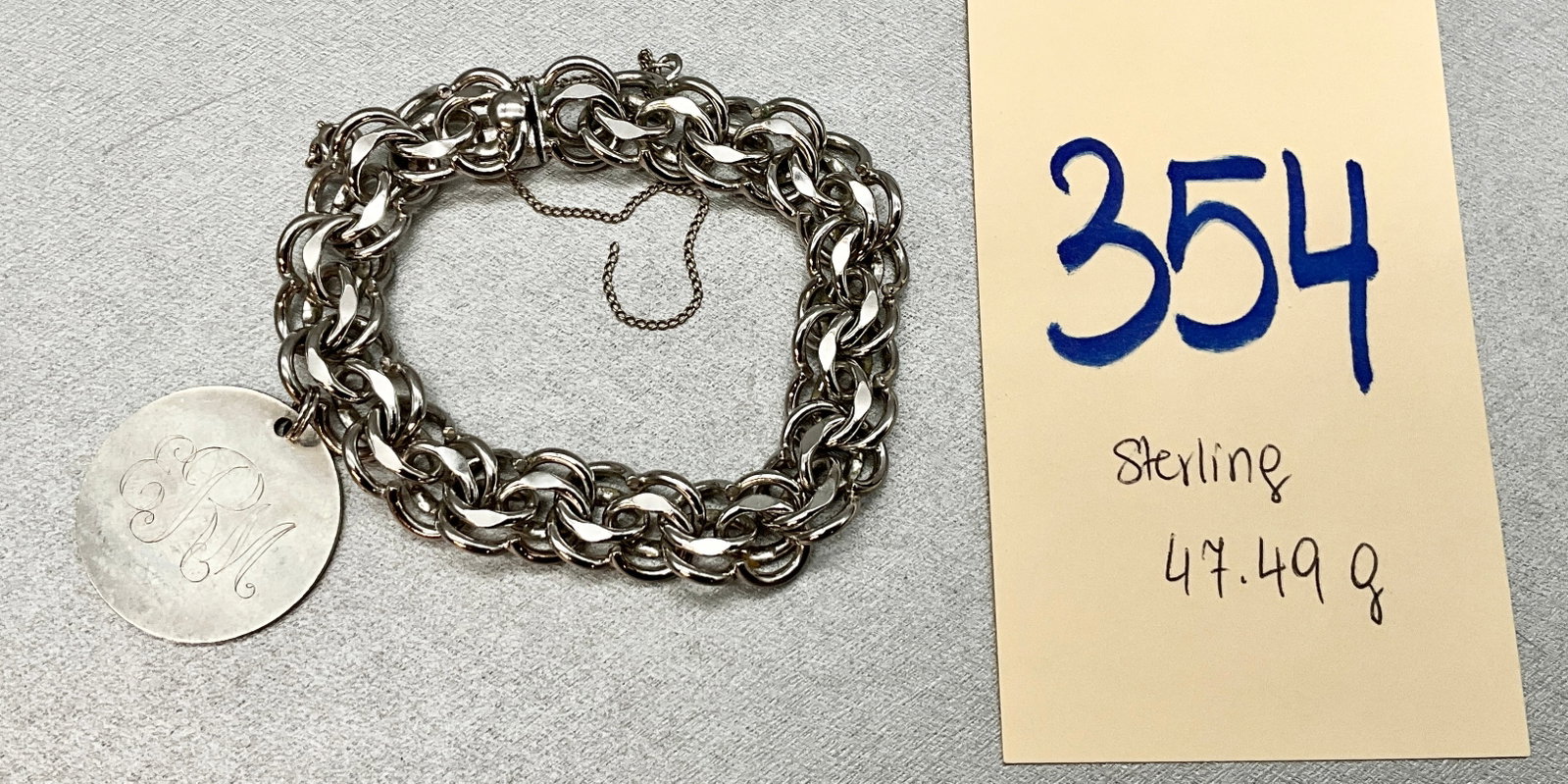 STERLING SILVER BRACELET WITH MONOGRAMMED FORSTNER CHARM.: STERLING SILVER BRACELET WITH MONOGRAMMED FORSTNER CHARM. TOTAL WEIGHT 47.49 GRAMS. Condition All property is sold in "as is" condition and all sales are final. Teel Auctions and its consignor make no