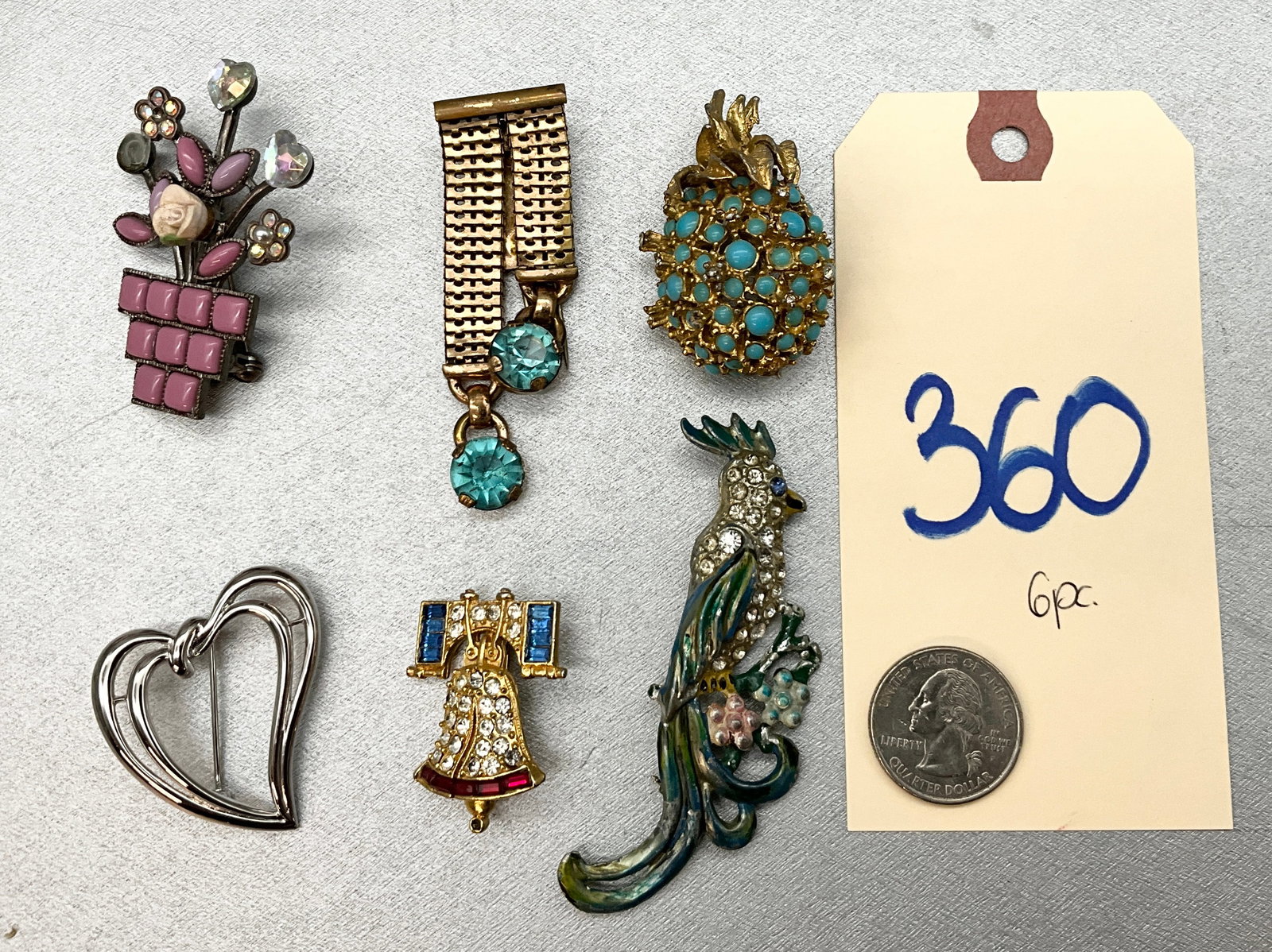 6 PC ASSORTED PARROT, BELL, AND MORE BROOCHES.: 6 PC ASSORTED PARROT, BELL, AND MORE BROOCHES. HEART BROOCH MARKED TRIFARI. Condition All property is sold in "as is" condition and all sales are final. Teel Auctions and its consignor make no represe