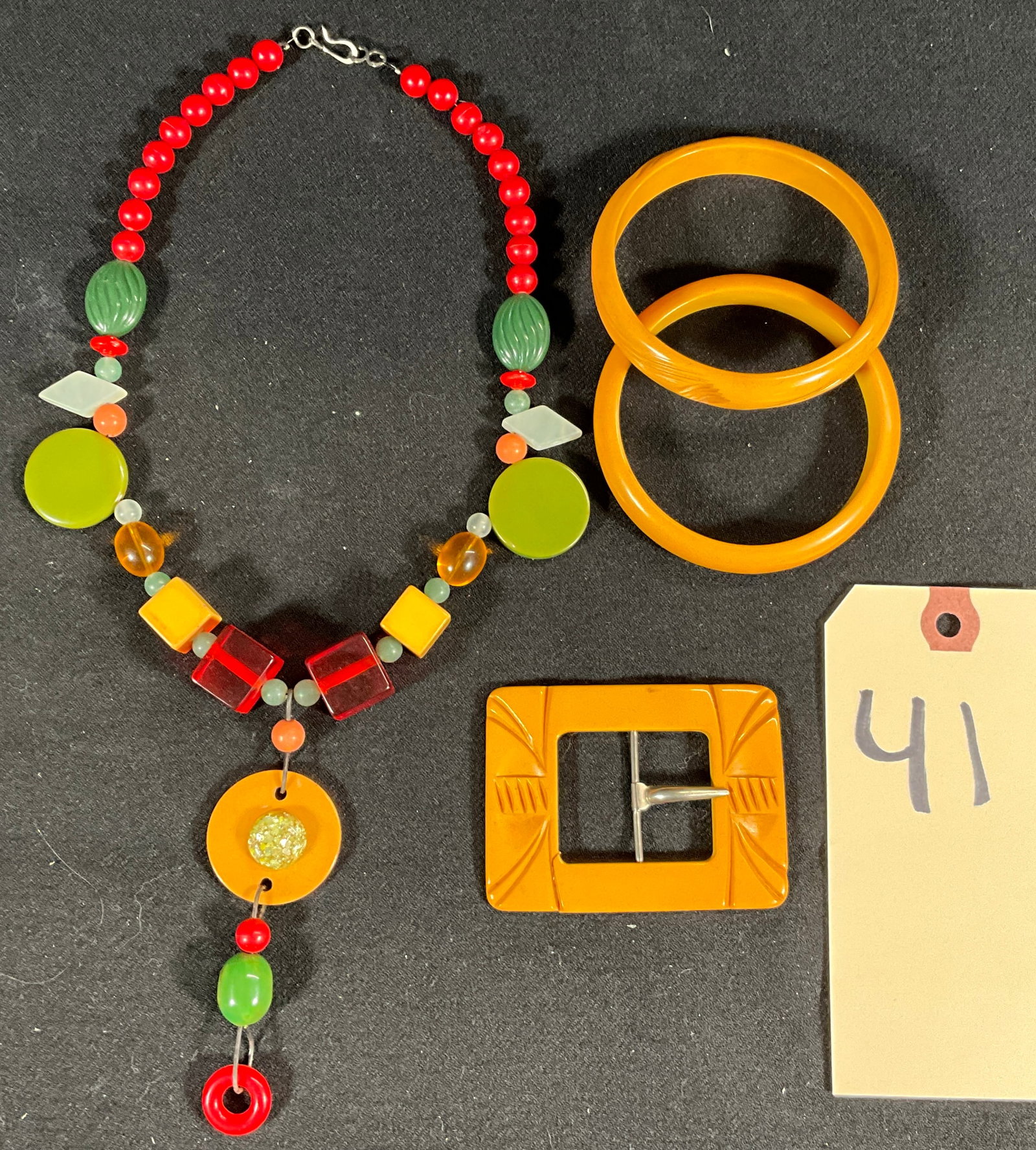 4 PC BAKELITE AND MIXED MEDIA BRACELETS, BELT BUCKLE, AND NECKLACE.: 4 PC BAKELITE AND MIXED MEDIA BRACELETS, BELT BUCKLE, AND NECKLACE. Condition All property is sold in "as is" condition and all sales are final. Teel Auctions and its consignor make no representations