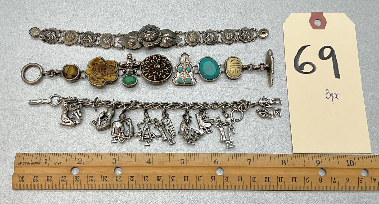 3 PC ASSORTED CHARM BRACELETS.: 3 PC ASSORTED CHARM BRACELETS. FLORAL, FIGURAL, AND MORE. Condition All property is sold in "as is" condition and all sales are final. Teel Auctions and its consignor make no representations or warran
