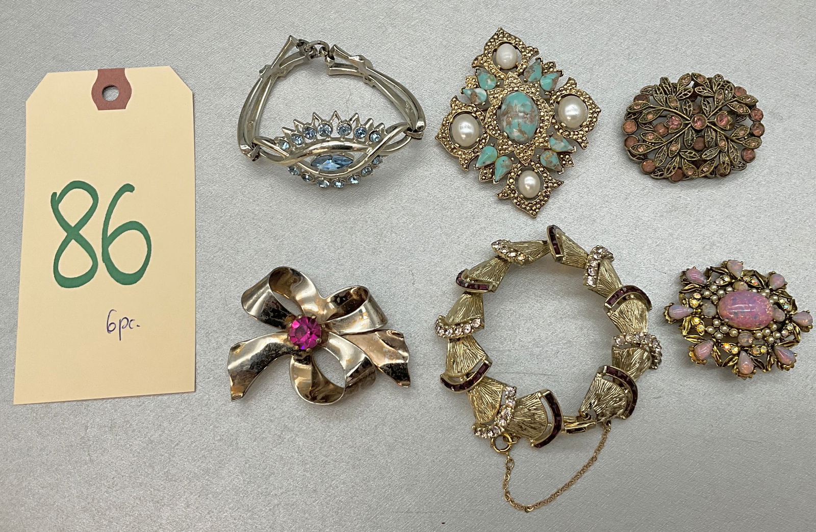 6 PC ASSORTED TURQUOISE AND RHINESTONE ENCRUSTED BROOCHES. SOME MARKED.: 6 PC ASSORTED TURQUOISE AND RHINESTONE ENCRUSTED BROOCHES. MARKINGS INCLUDE CORO, SARAH COV., HOLLYCRAFT, AND OTHERS. Condition All property is sold in "as is" condition and all sales are final. Teel