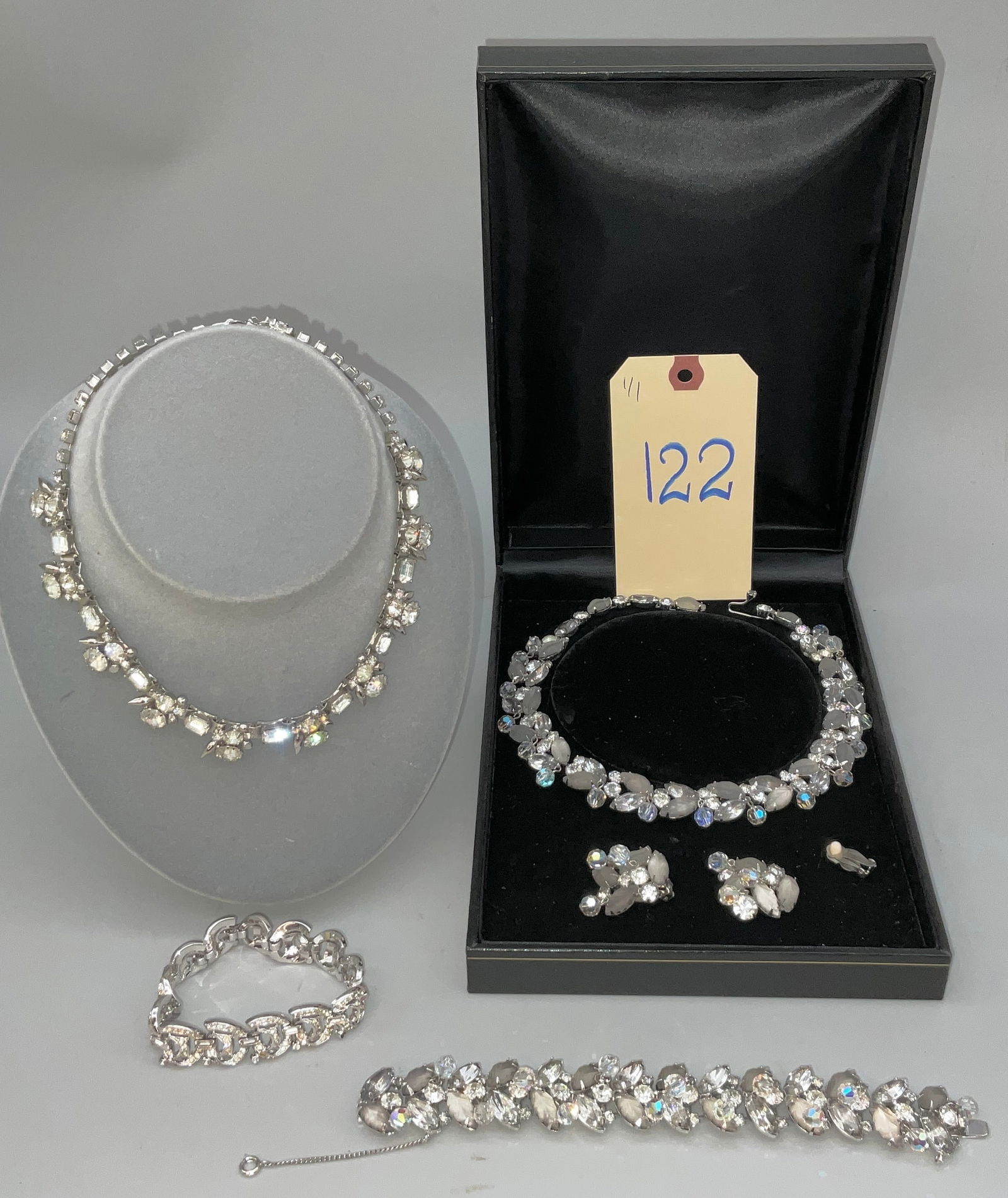 KRAMER OF NY AND MORE CRYSTAL RHINESTONE ENCRUSTED JEWELRY LOT: KRAMER OF NY AND MORE CRYSTAL RHINESTONE ENCRUSTED JEWELRY LOT. PLEASE NOTE ONE EARRING HAS DETACHED FROM THE CLASP, BUYING AS IS. Condition All property is sold in "as is" condition and all sales are