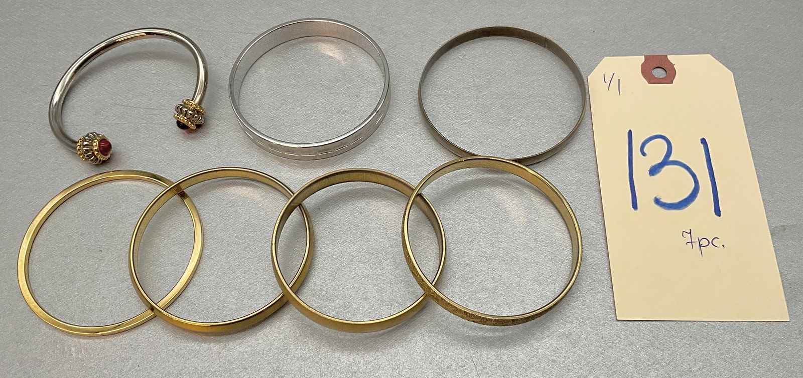 7 PC MONET HOOP BRACELETS.: 7 PC MONET HOOP BRACELETS. Condition All property is sold in "as is" condition and all sales are final. Teel Auctions and its consignor make no representations or warranties, express or implied, with
