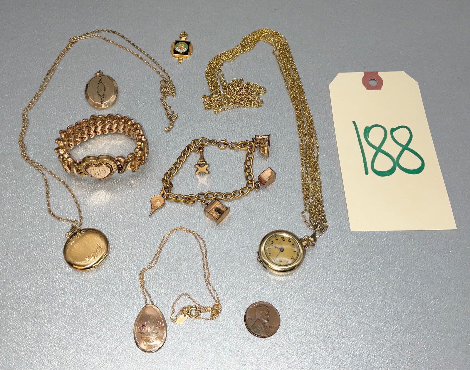 7 PC CHARM BRACELET, LOCKET NECKLACES, PENDANTS, AND MORE.: 7 PC CHARM BRACELET, LOCKET NECKLACES, PENDANTS, AND MORE. LOT INCLUDES CORO GOLD FILLED WATCH, KINNEY CHARM, AND MORE. Condition All property is sold in "as is" condition and all sales are final. Tee
