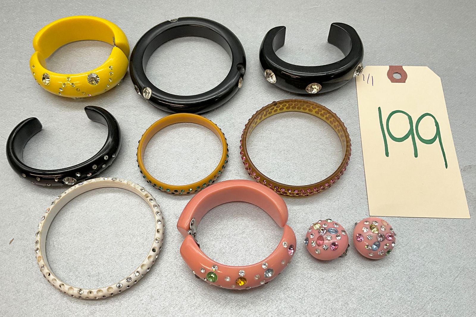 10 PC RHINESTONE DECORATED CUFF BRACELETS AND EARRINGS.: 10 PC RHINESTONE DECORATED CUFF BRACELETS AND EARRINGS. Condition All property is sold in "as is" condition and all sales are final. Teel Auctions and its consignor make no representations or warranti