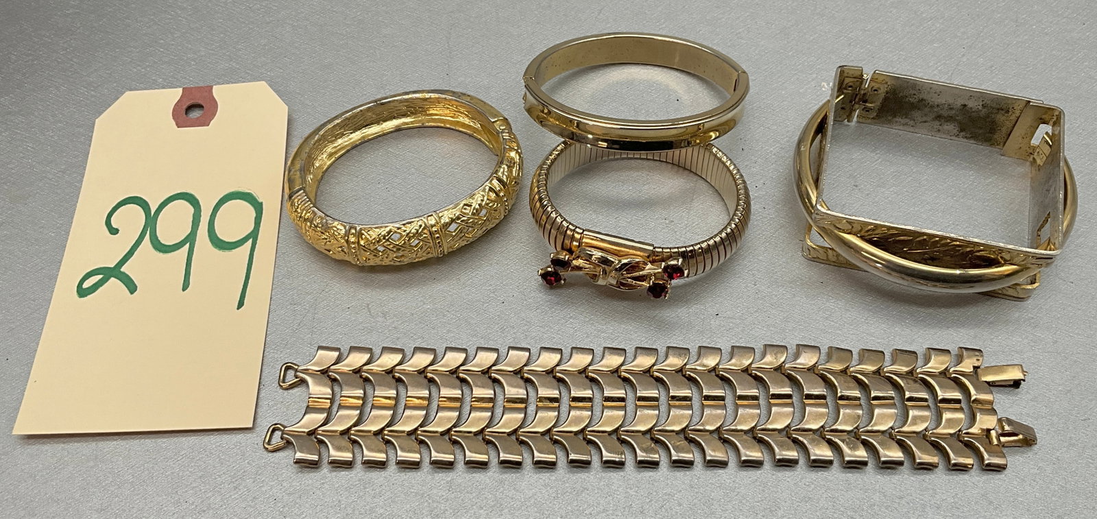5 PC GOLD COLORED BRACELETS FROM PAUL CARVED AND OTHERS.: 5 PC GOLD COLORED BRACELETS FROM PAUL CARVED AND OTHERS. Condition All property is sold in "as is" condition and all sales are final. Teel Auctions and its consignor make no representations or warrant
